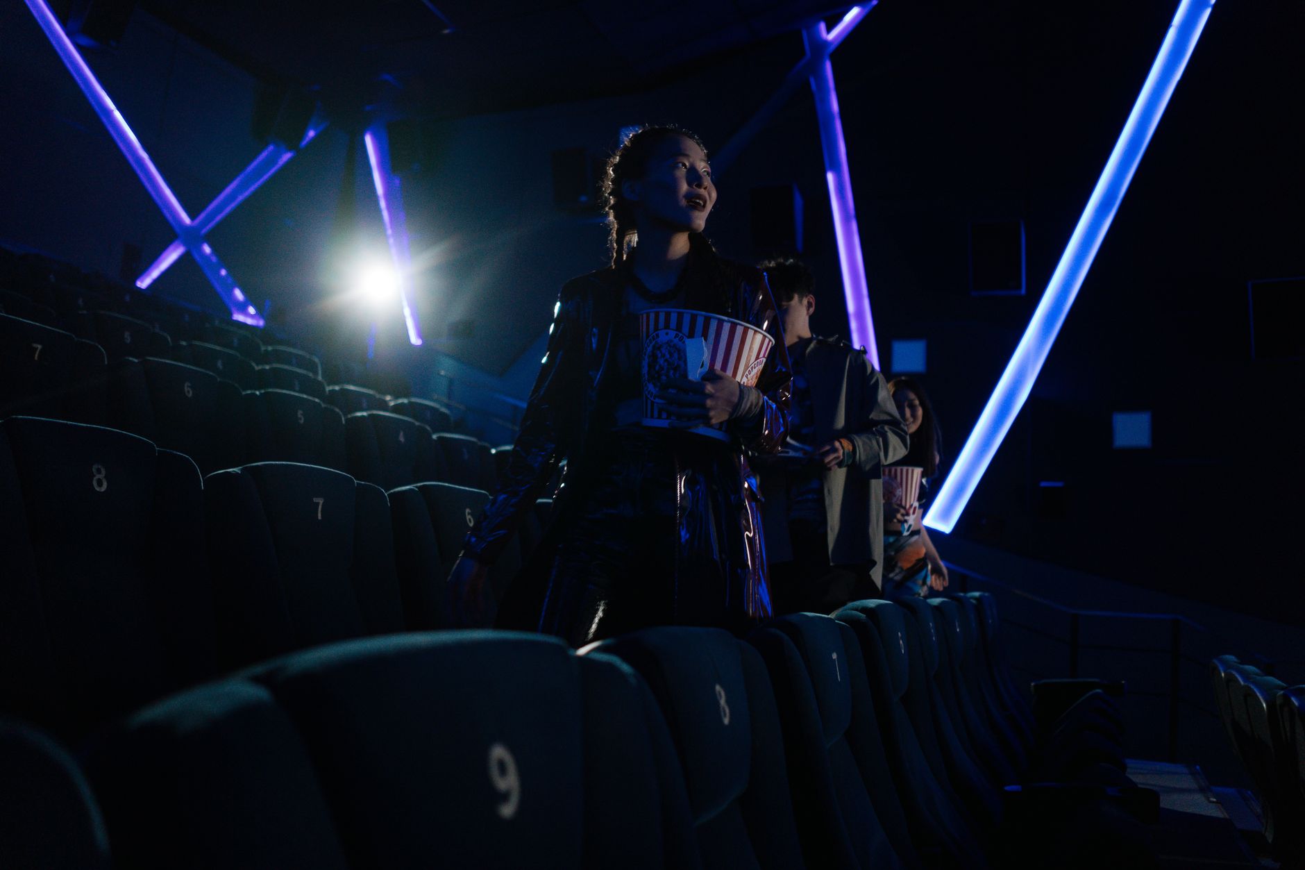 cinema theater hall dark seats with screen glow