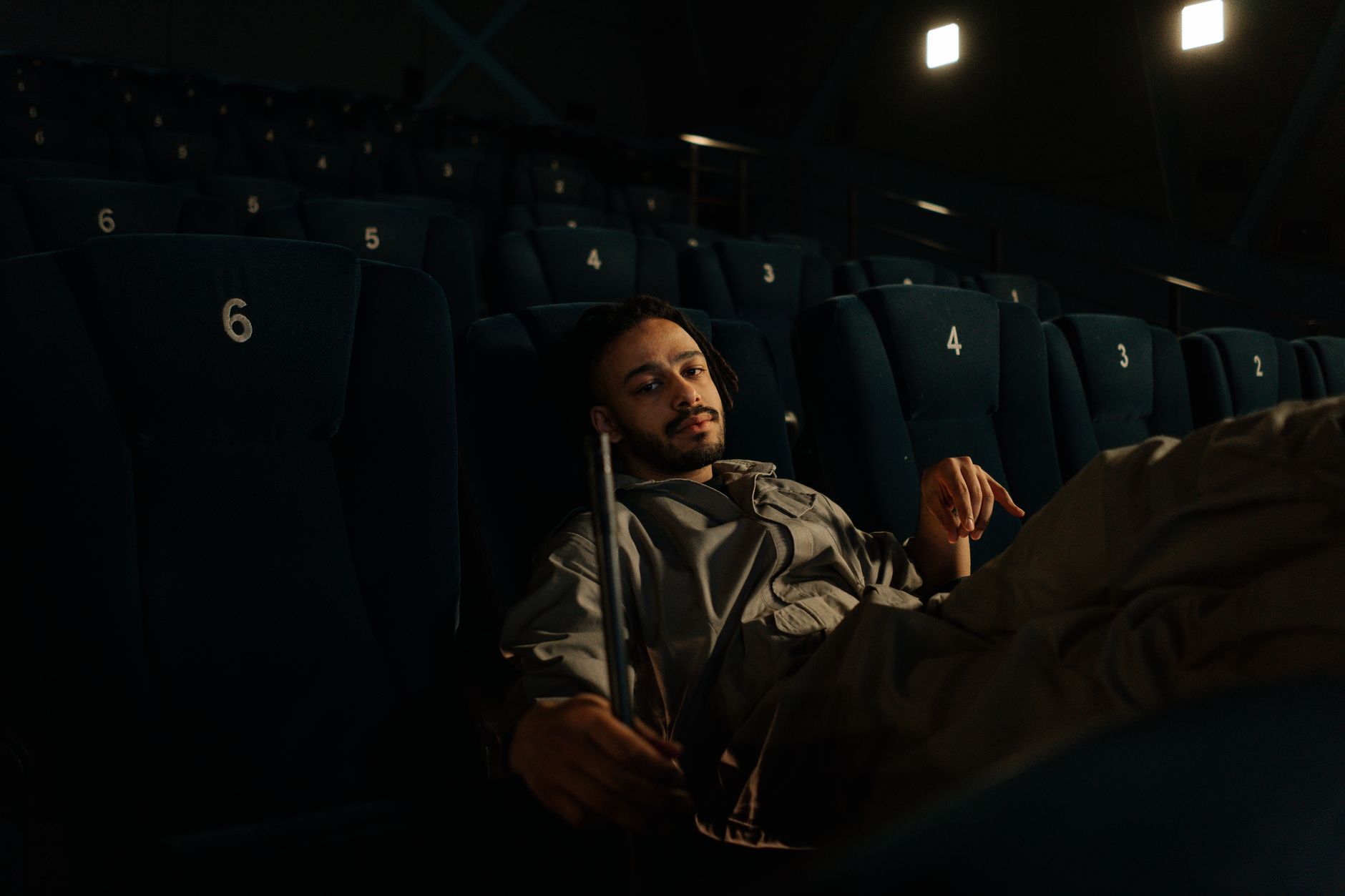 person watching thriller movie alone dark room
