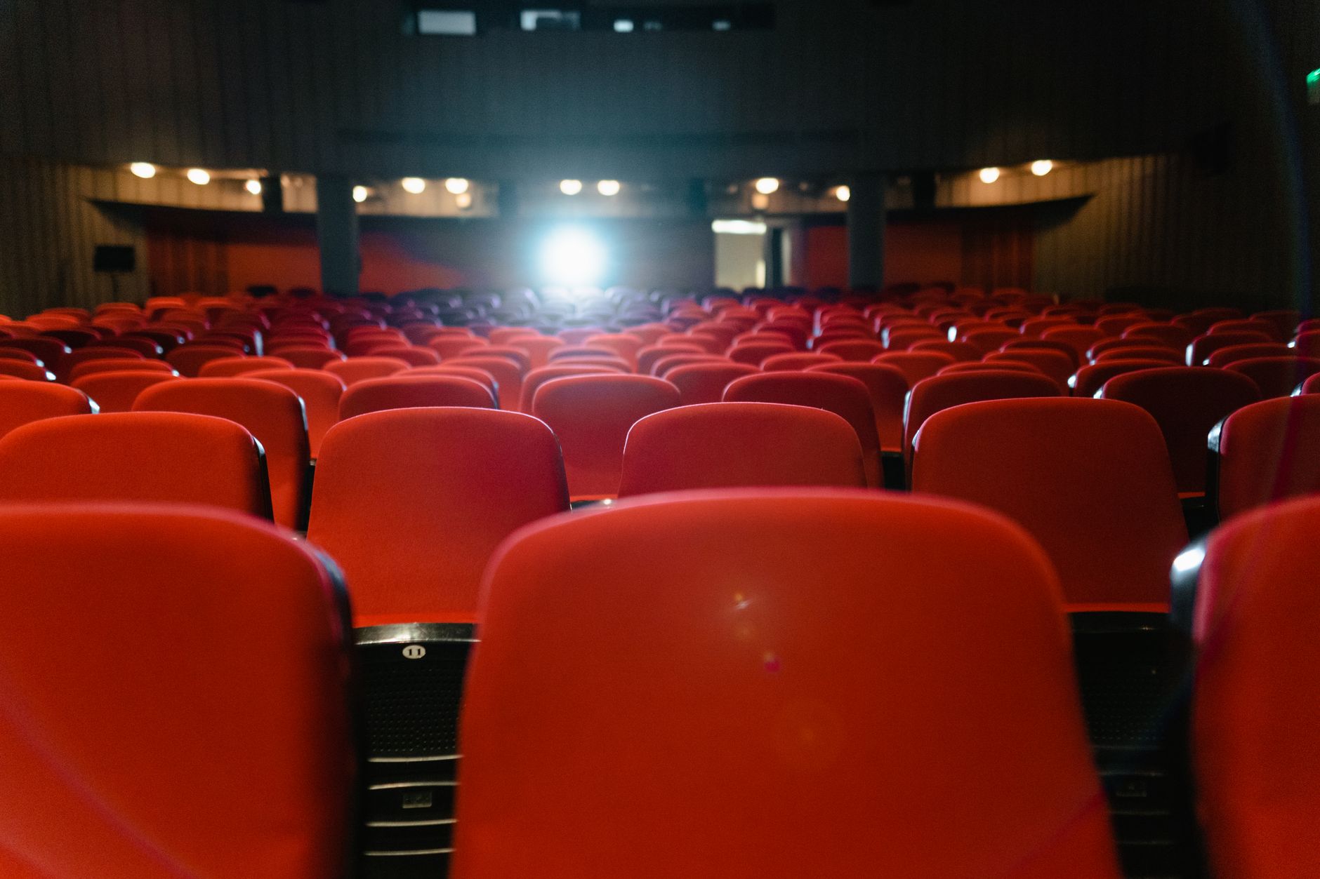 cinema theater hall dark seats with screen glow