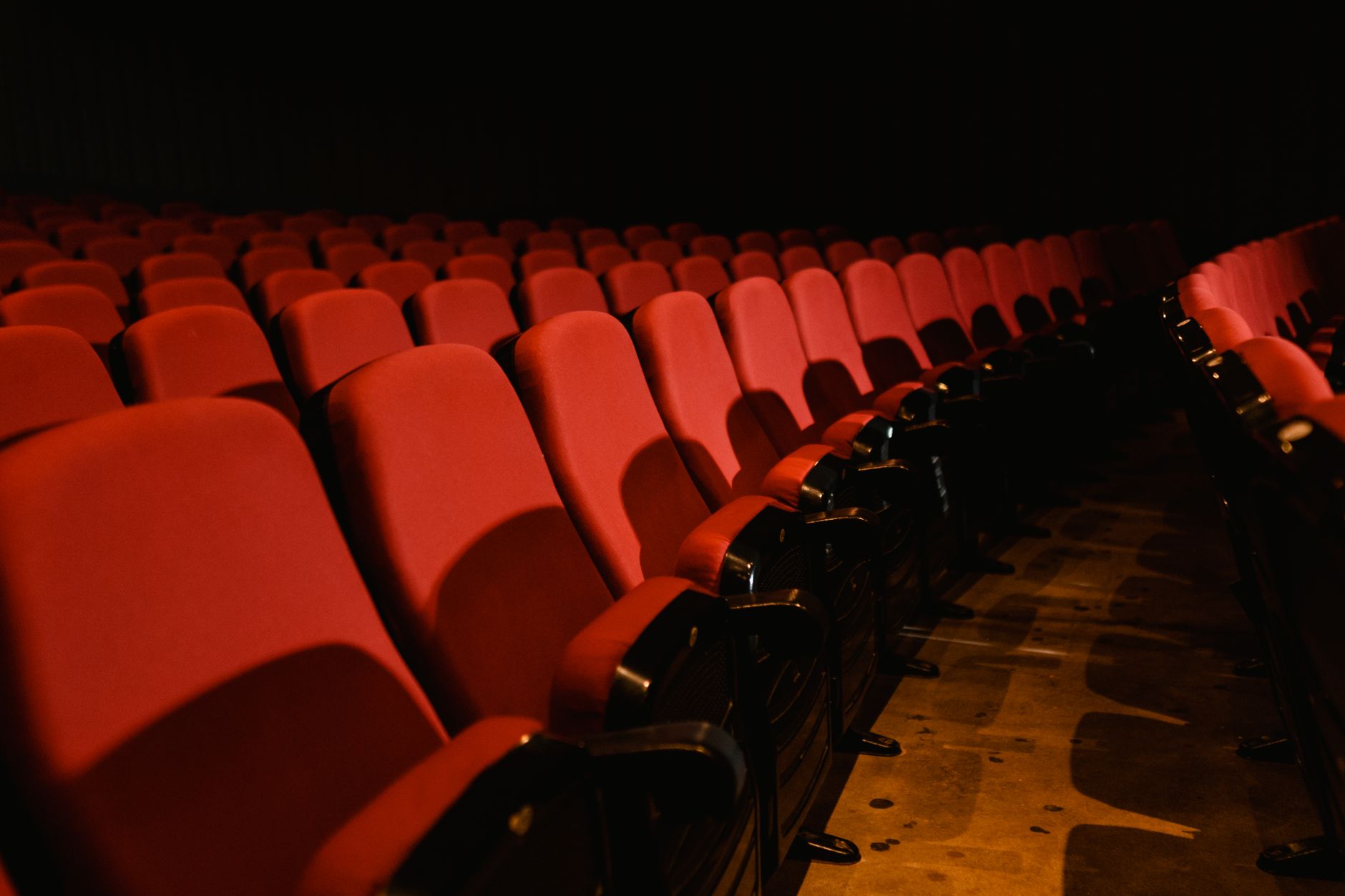 cinema theater hall dark seats with screen glow