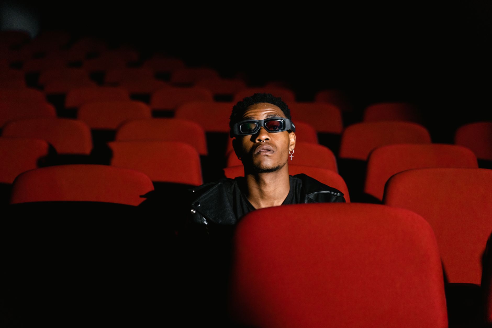 person watching thriller movie alone dark room