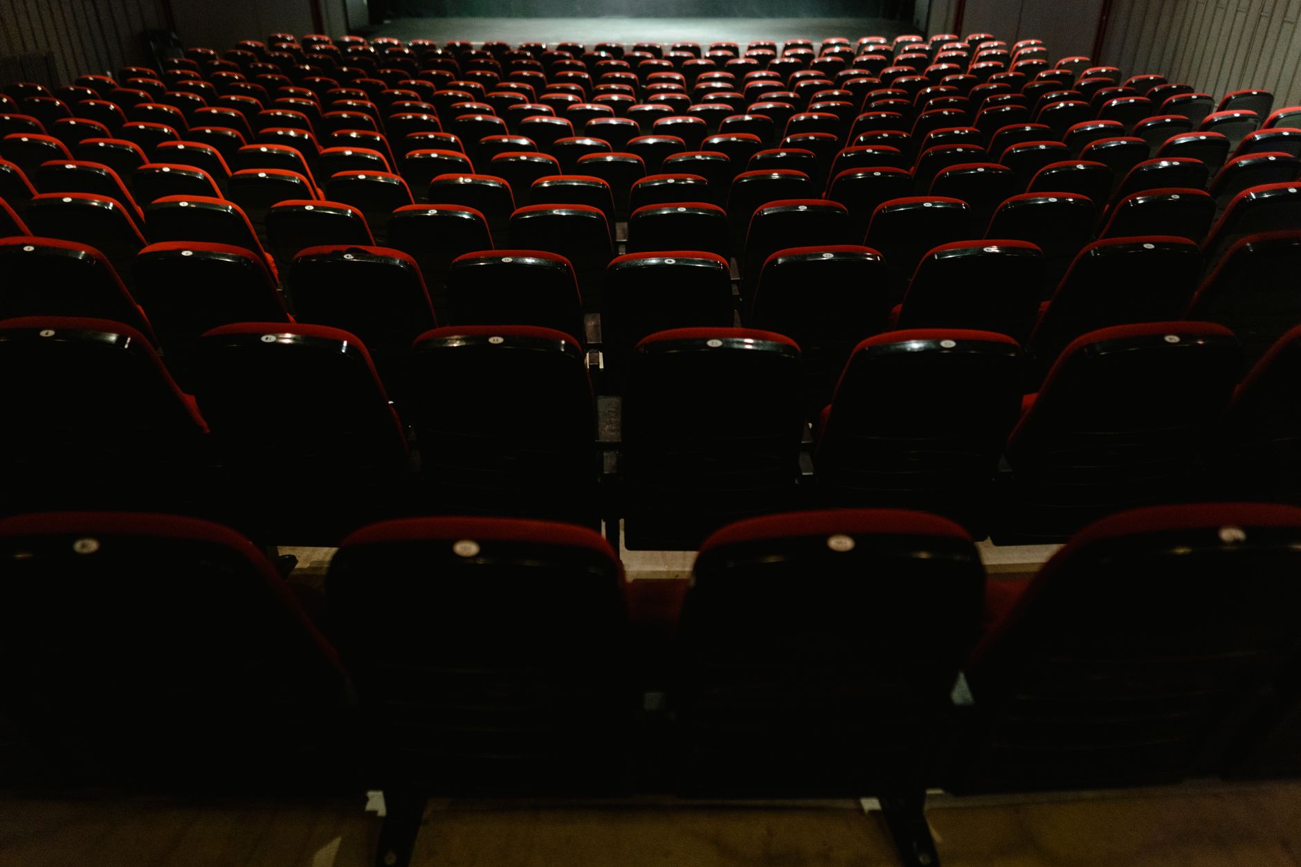 cinema theater hall dark seats with screen glow