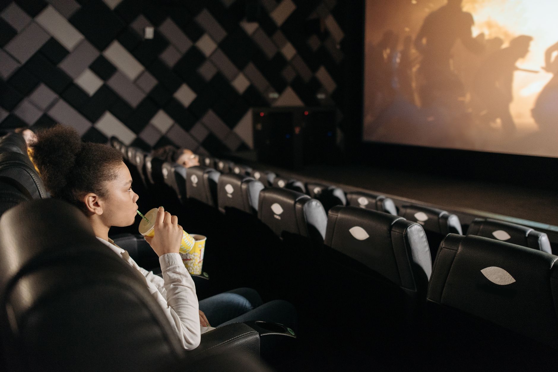 person watching thriller movie alone dark room