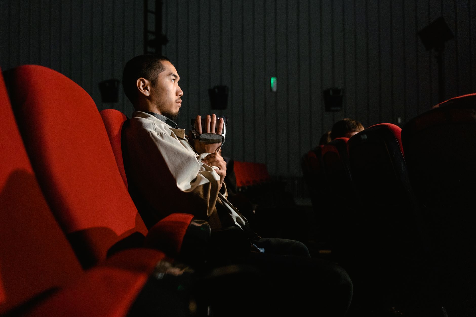 person watching thriller movie alone dark room
