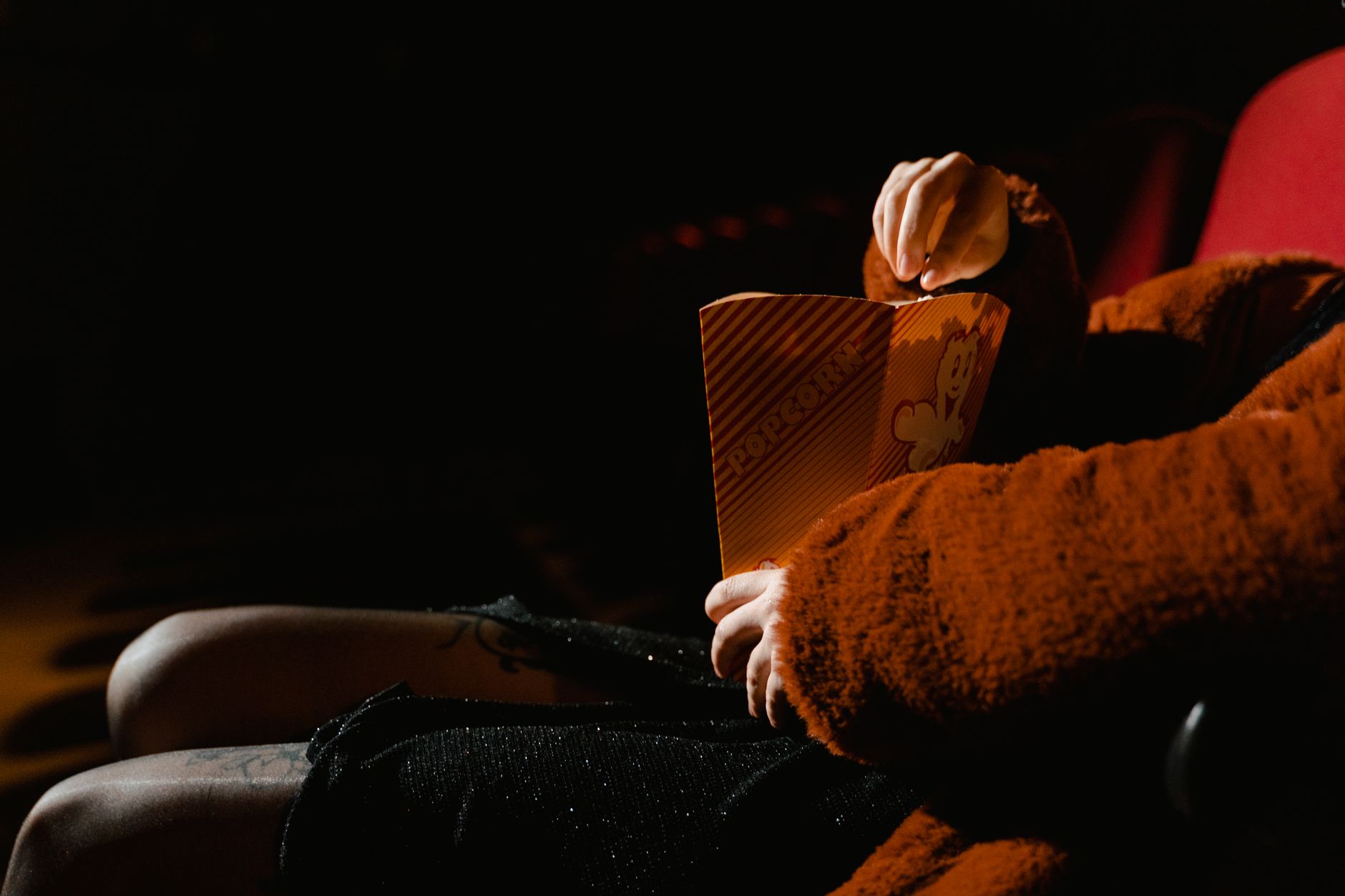 person watching thriller movie alone dark room