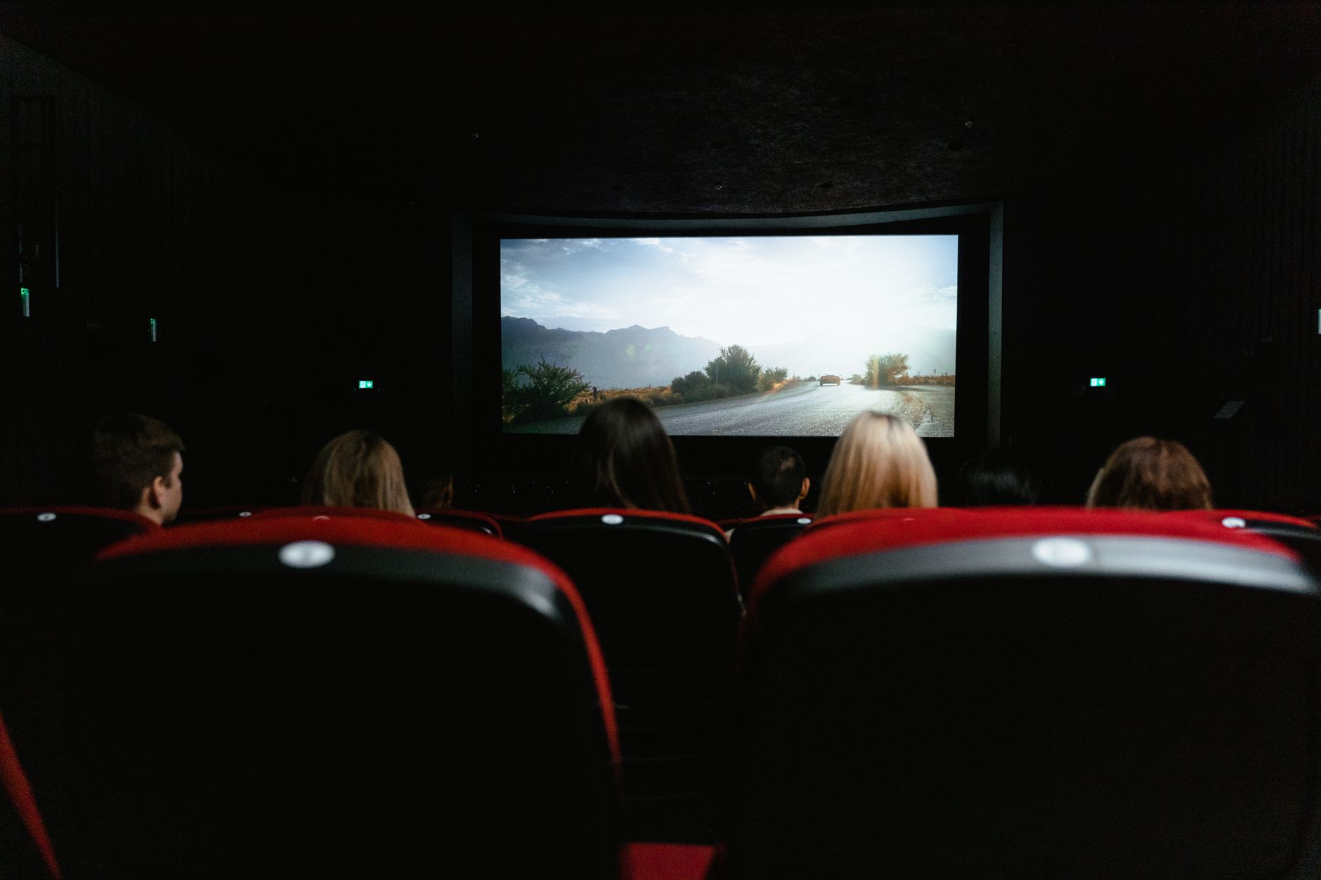cinema theater hall dark seats with screen glow