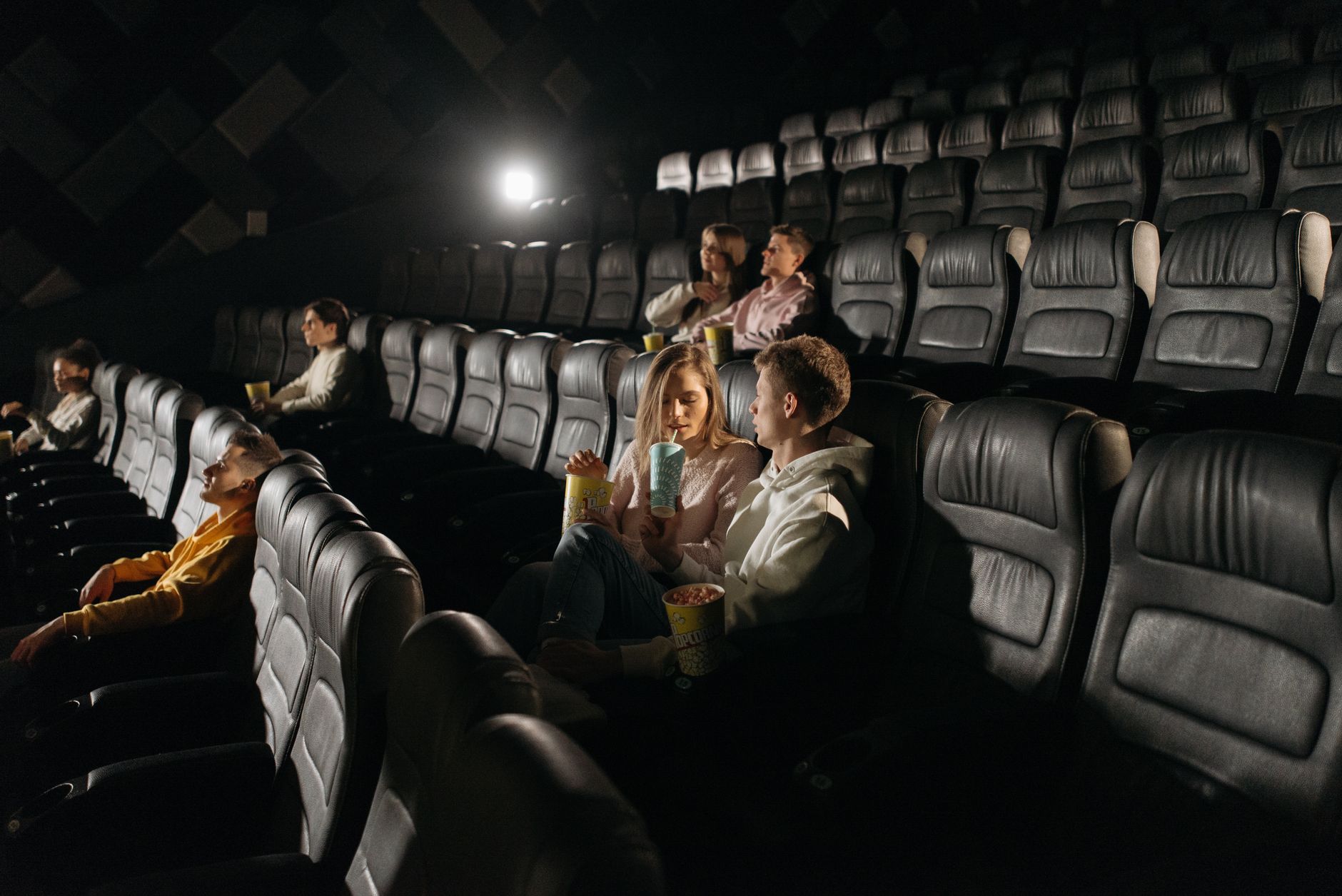audience watching movie in dark cinema hall