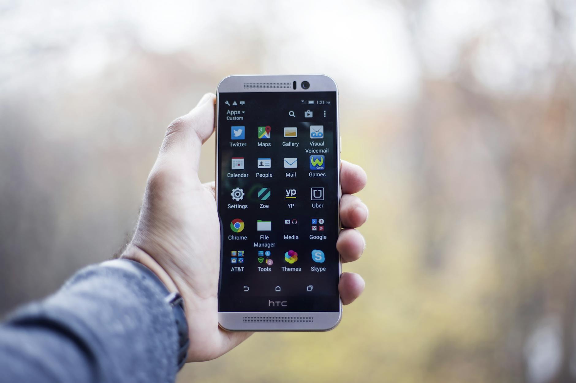 hand holding android phone with bright screen outdoor
