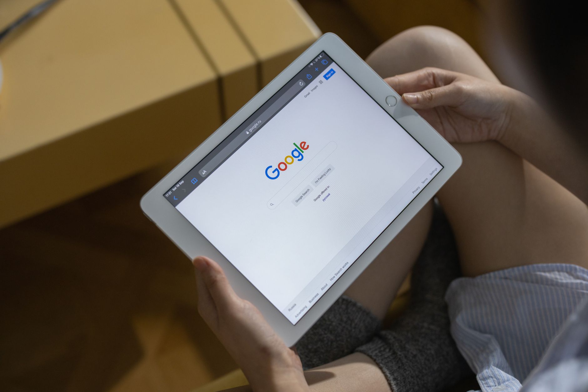 hands holding tablet browsing website