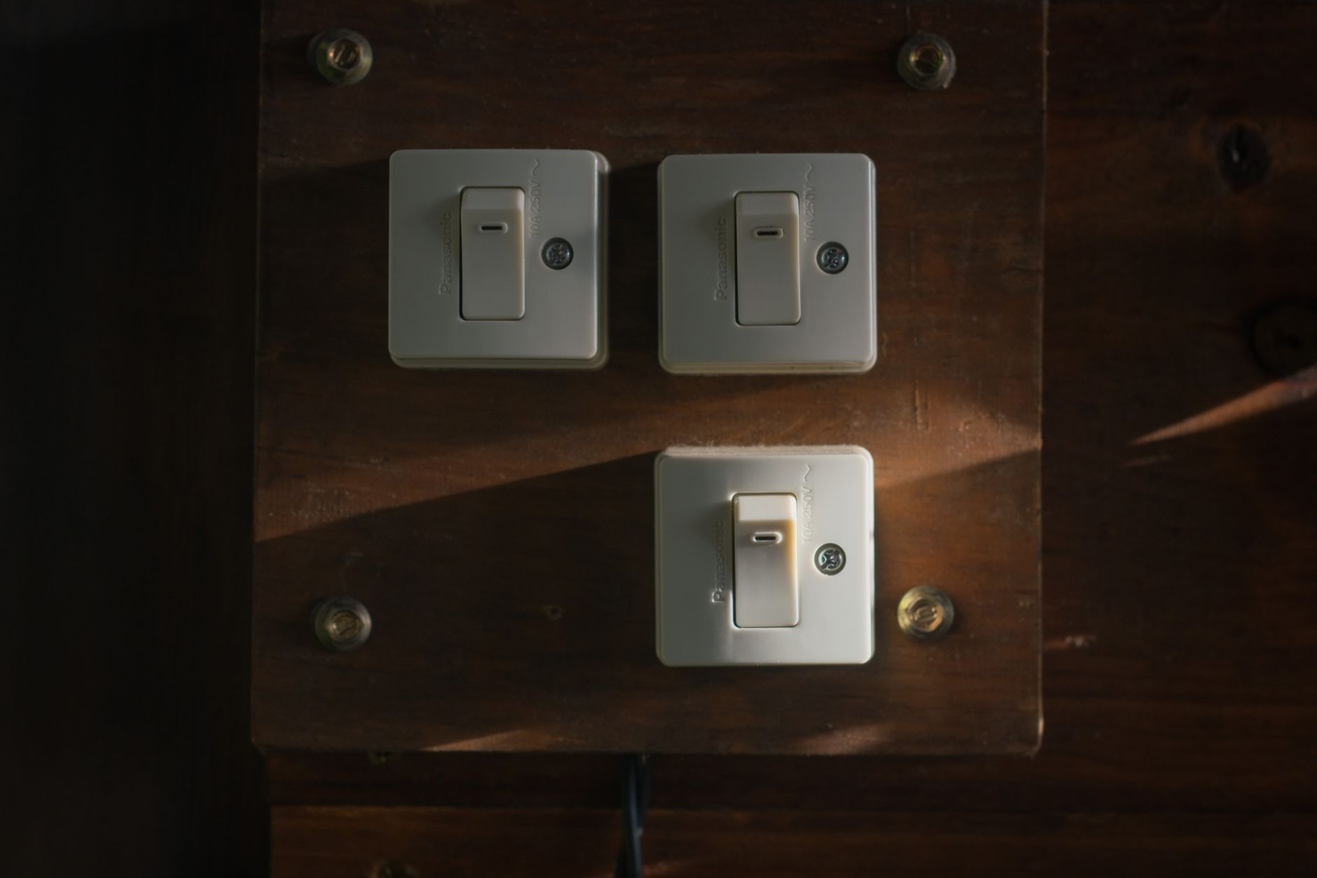 hand turning off light switch at home evening