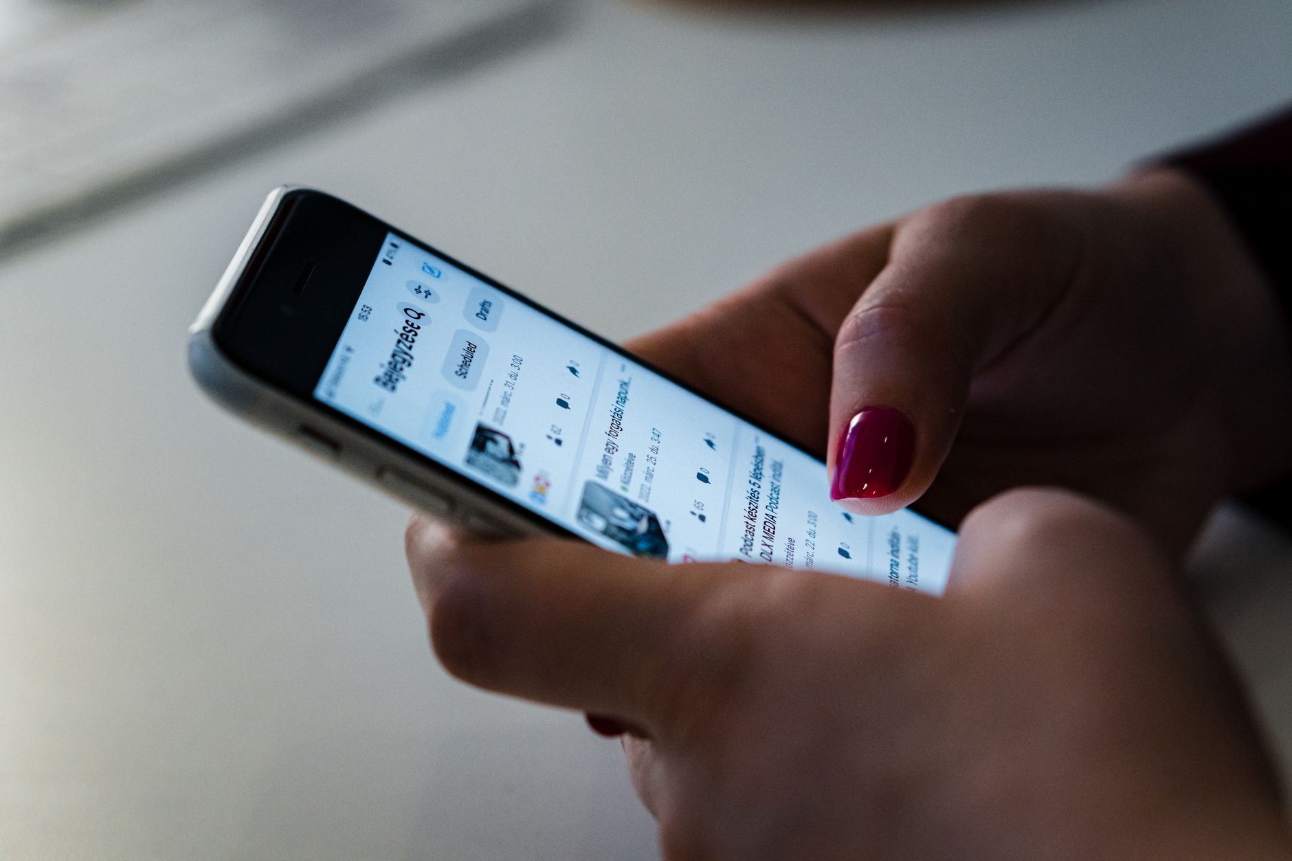 hand holding smartphone browsing social media