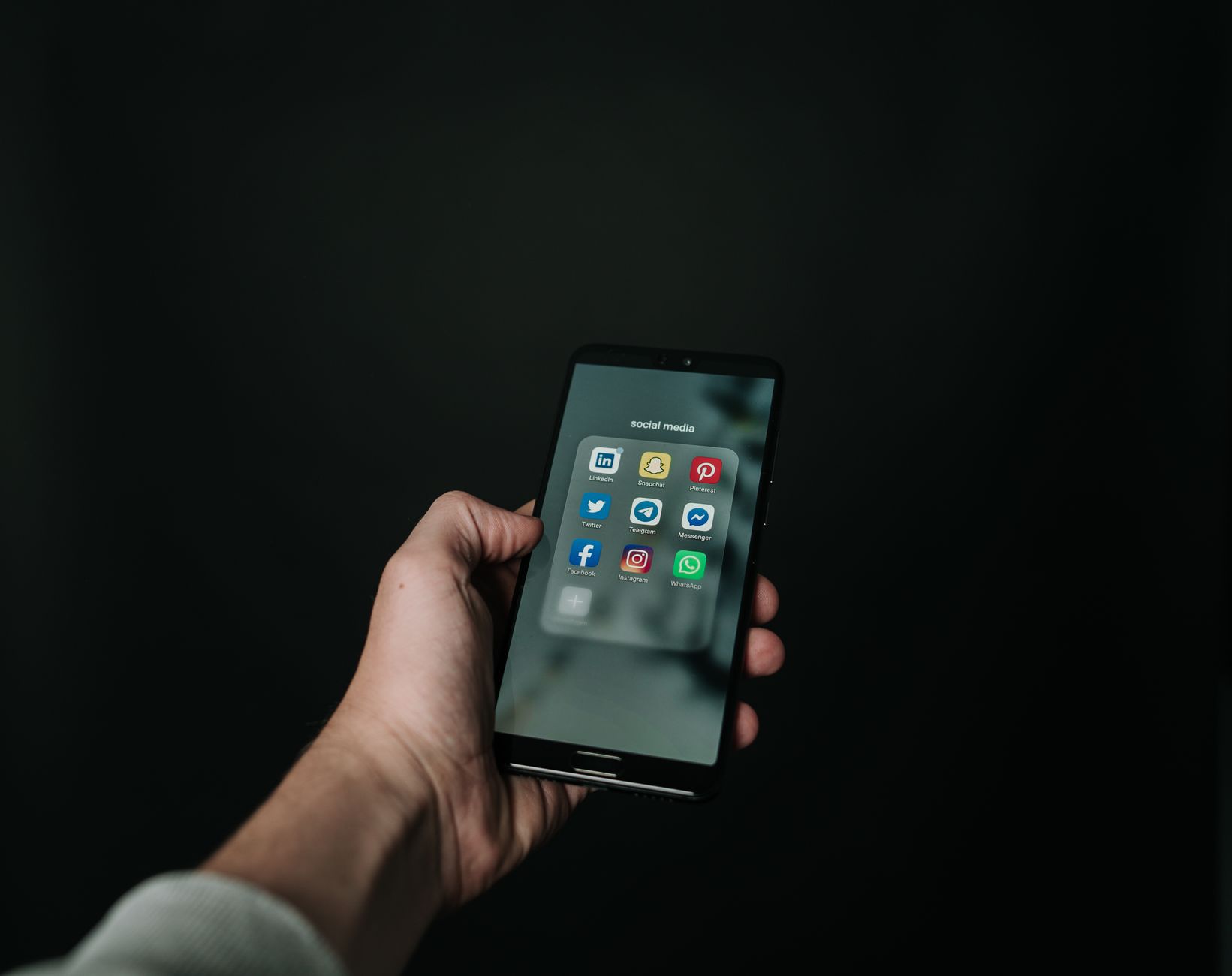 person holding smartphone with WhatsApp chat screen
