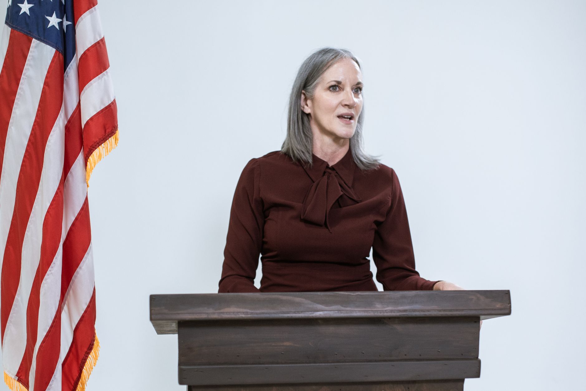 government official speaking at podium microphone