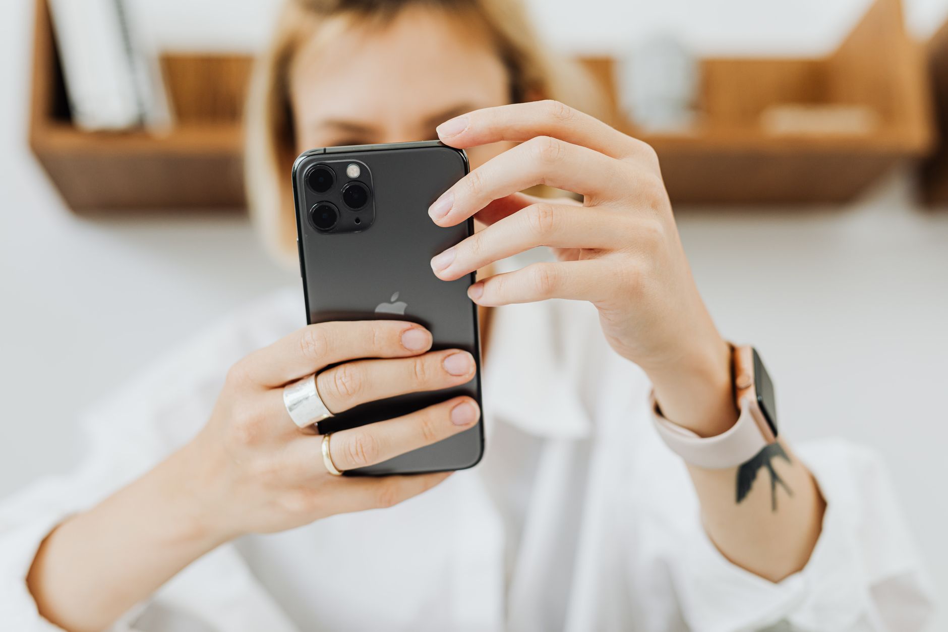 Woman holding smartphone in office