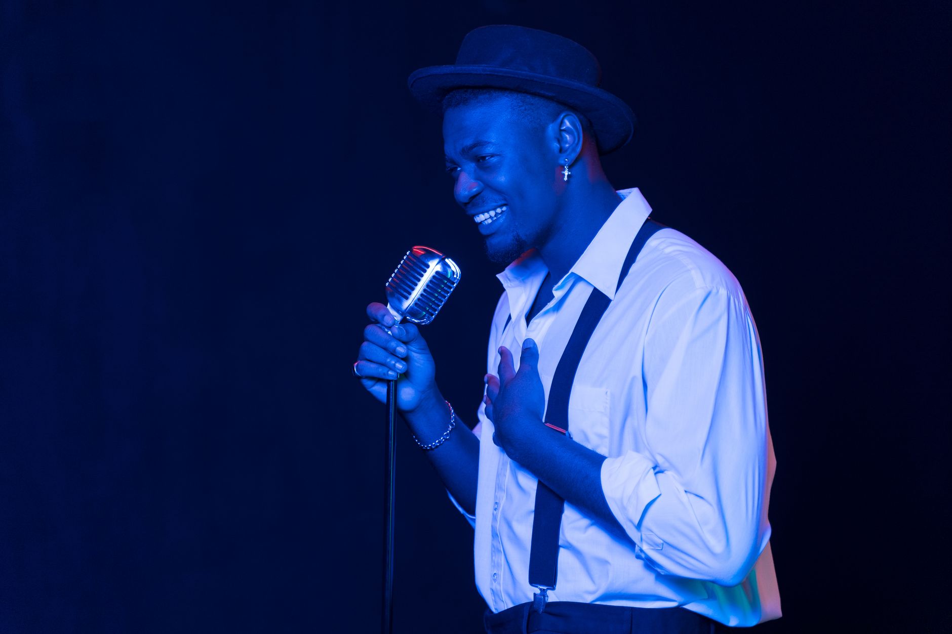 singer performing on stage spotlight with microphone