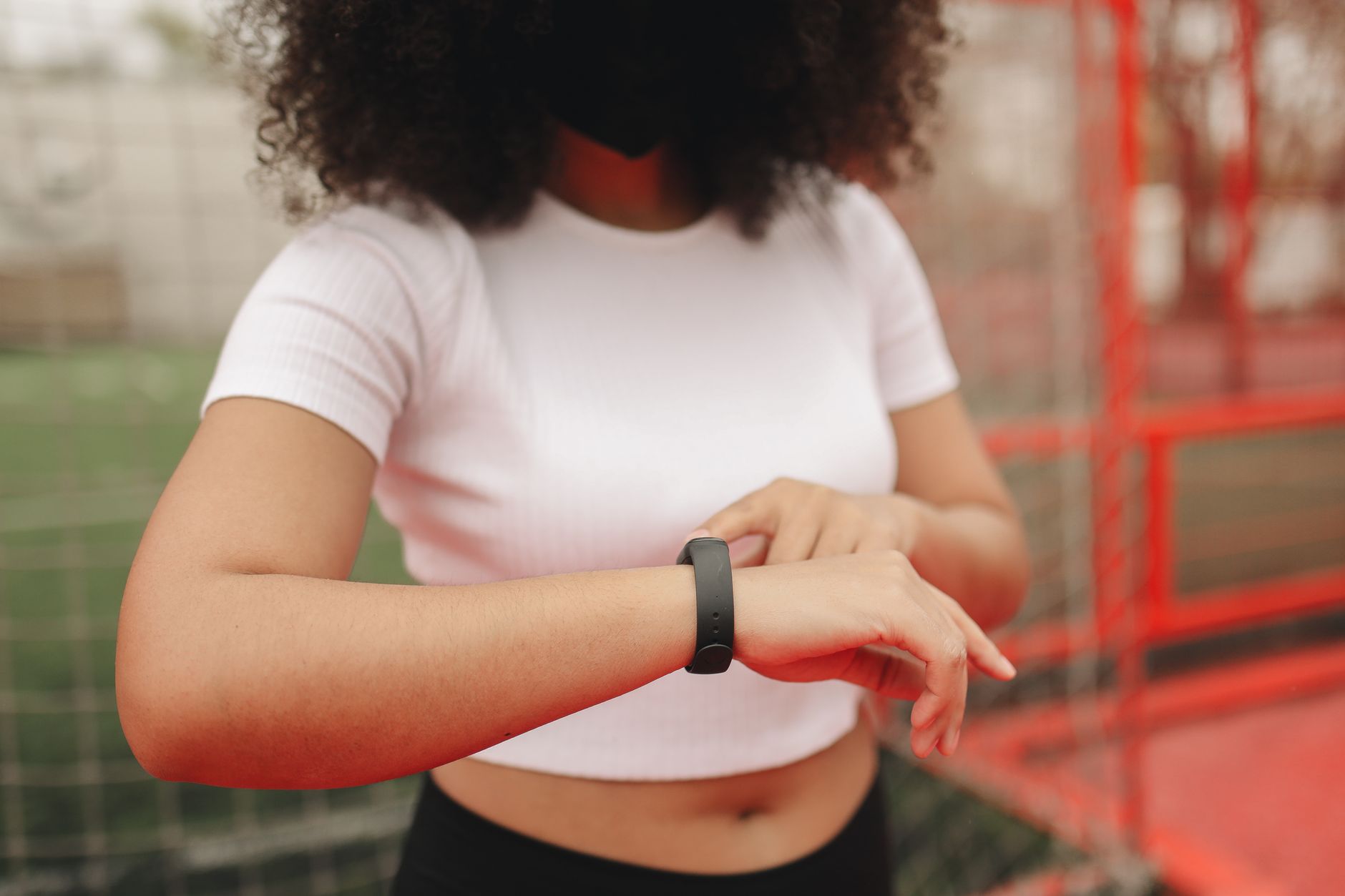 athlete checking smartwatch heart rate outdoor trail