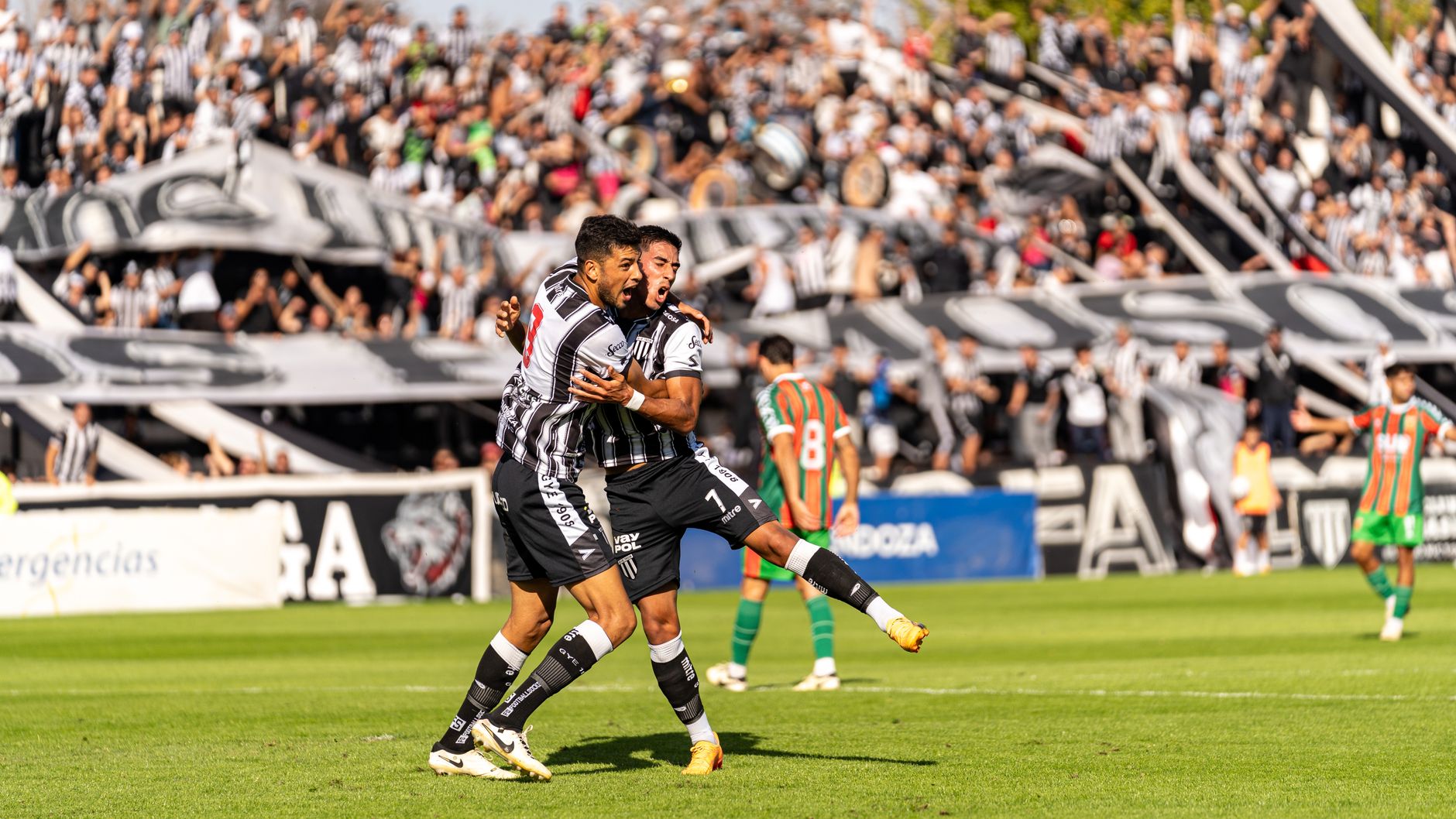 football players celebrating goal on field stadium