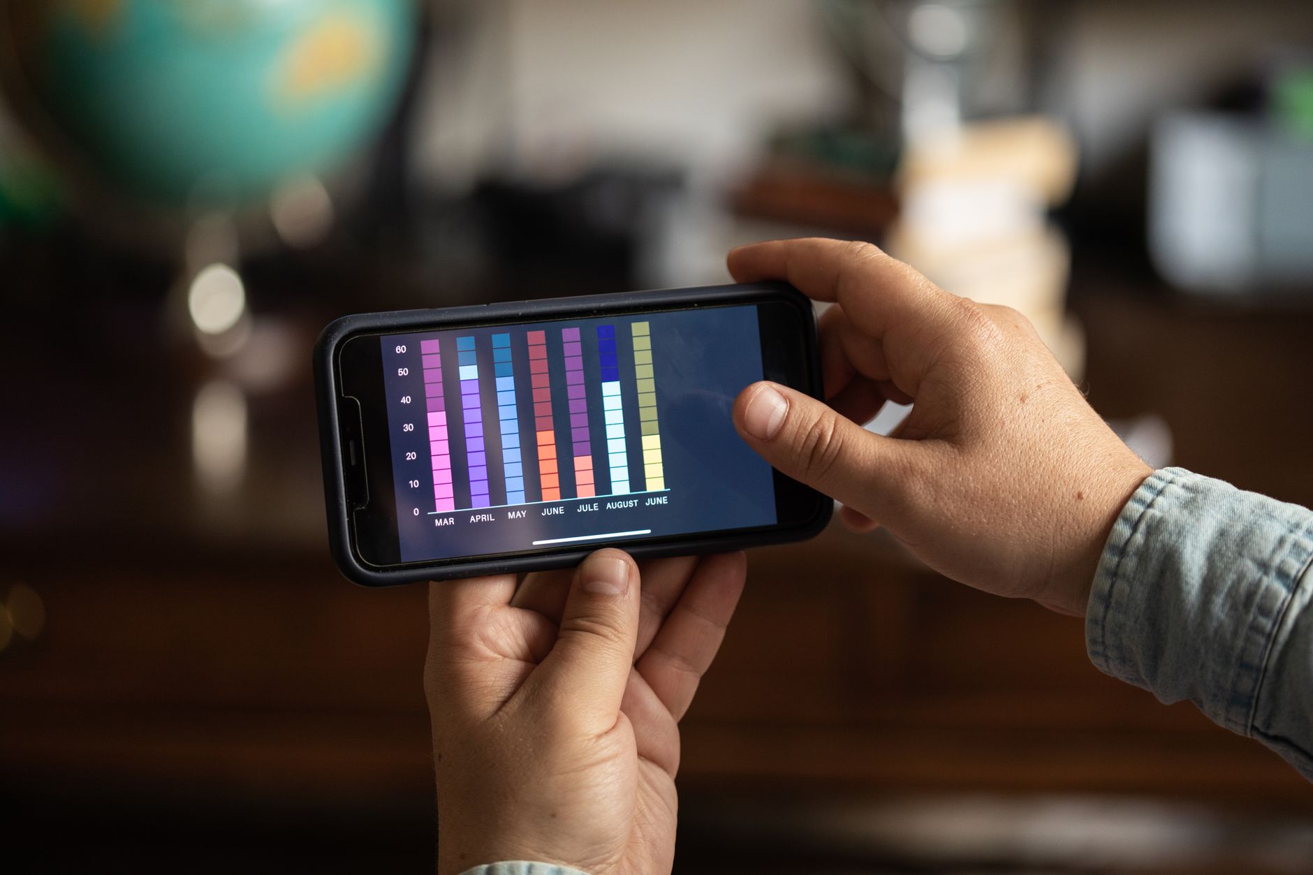 Hand holding smartphone showing low signal bars