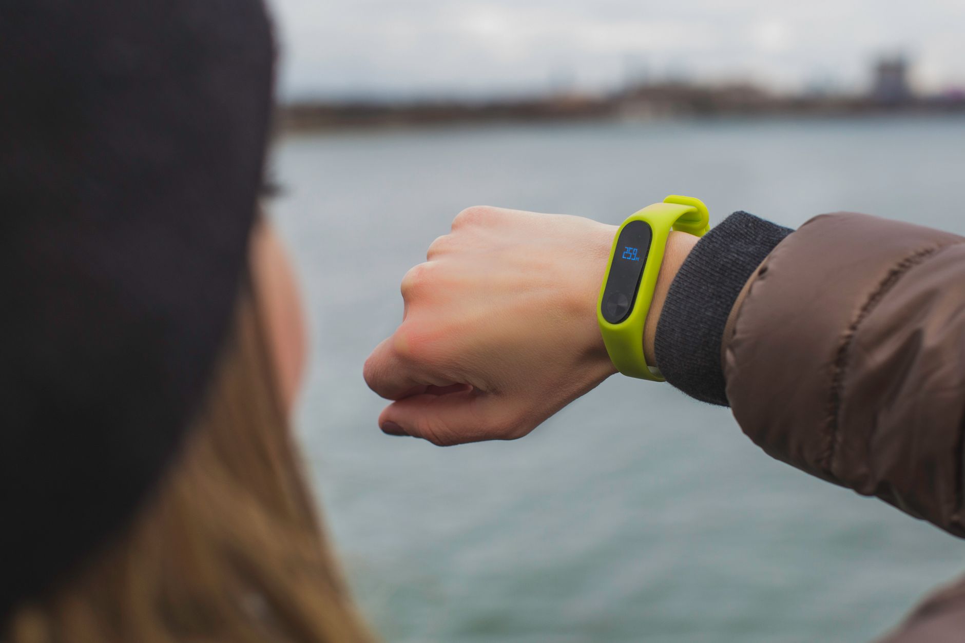 runner checking smartwatch on wrist park