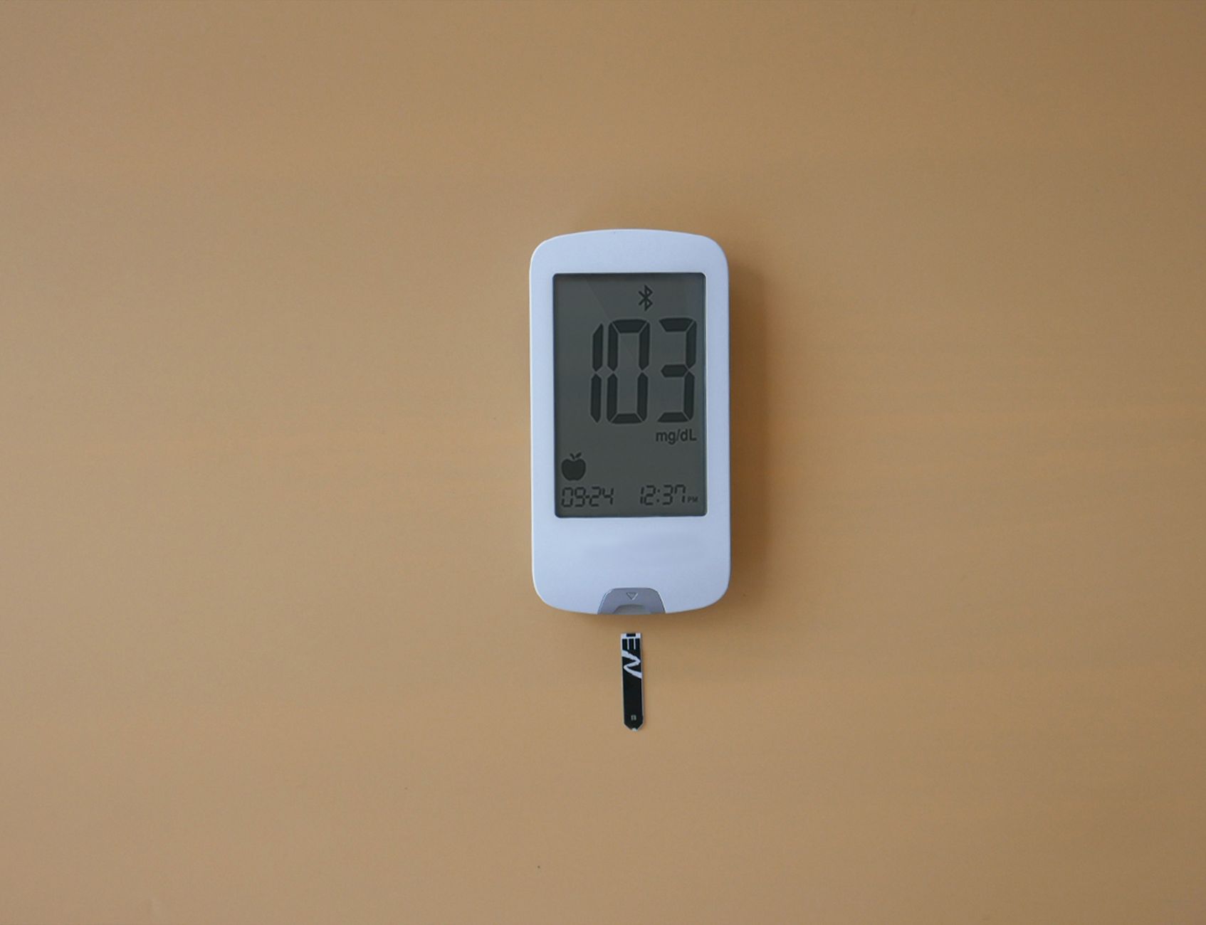 person checking digital electricity meter display on wall