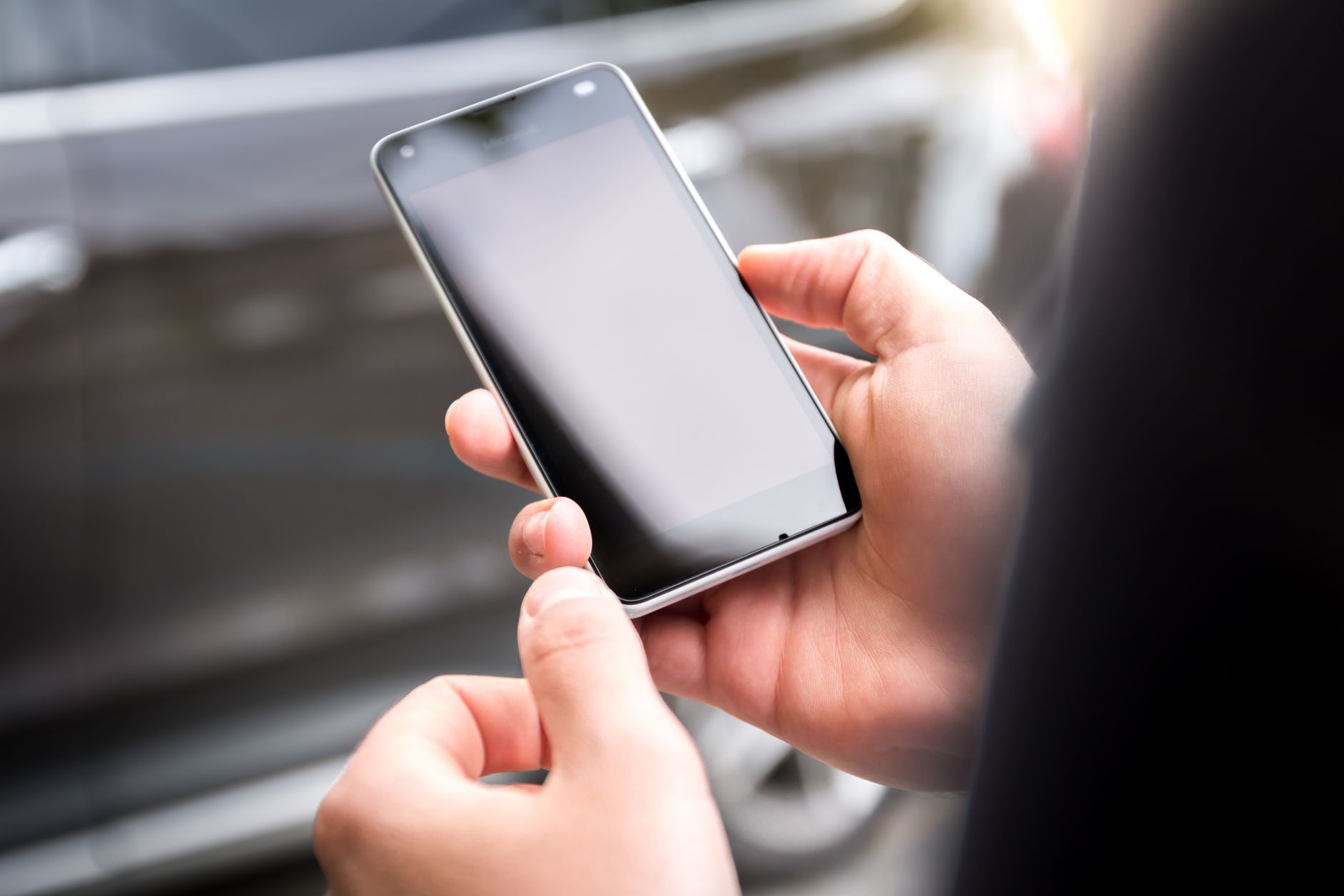 person hands holding smartphone checking car tax info