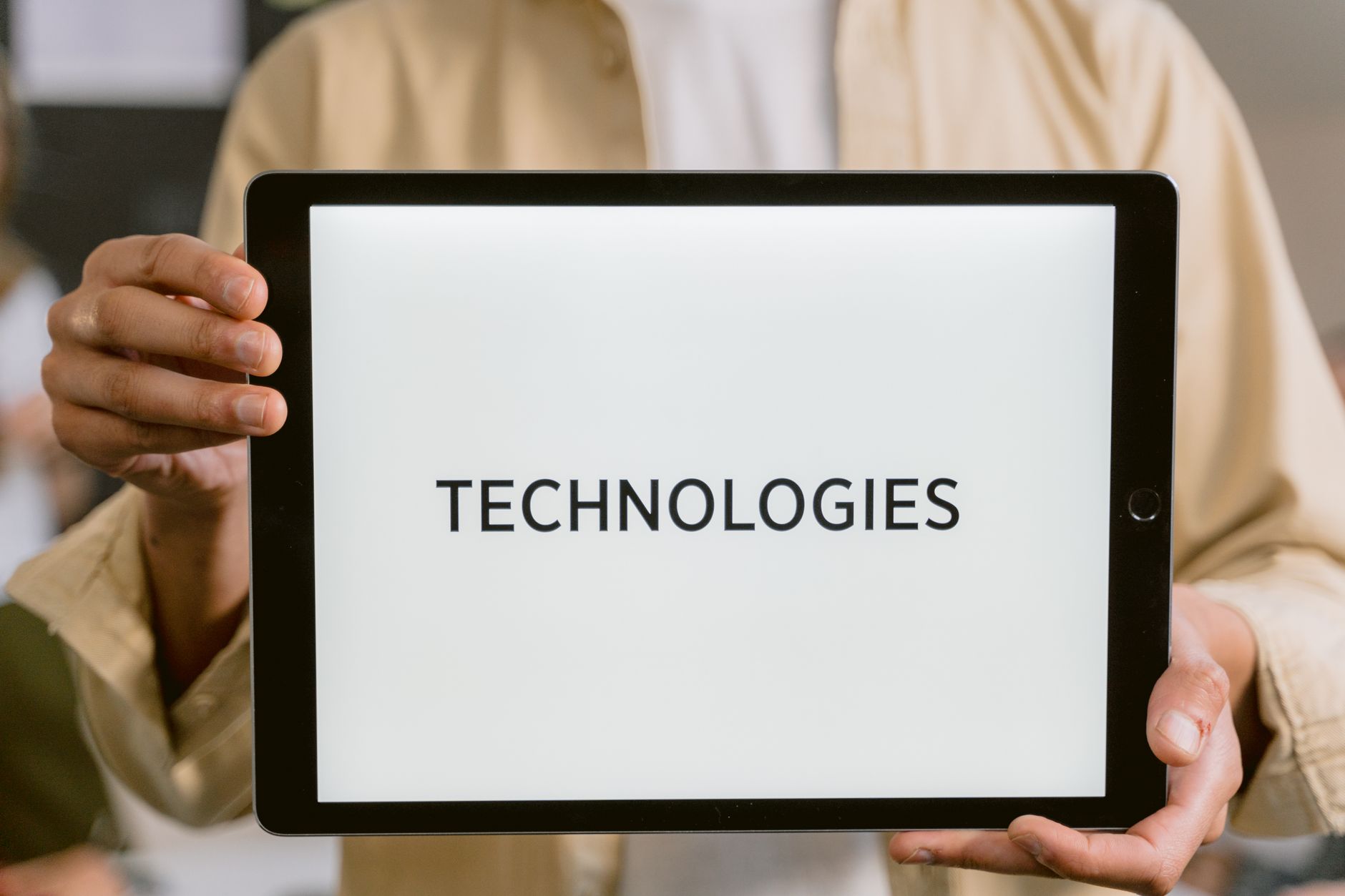 Person holding a tablet near a power meter