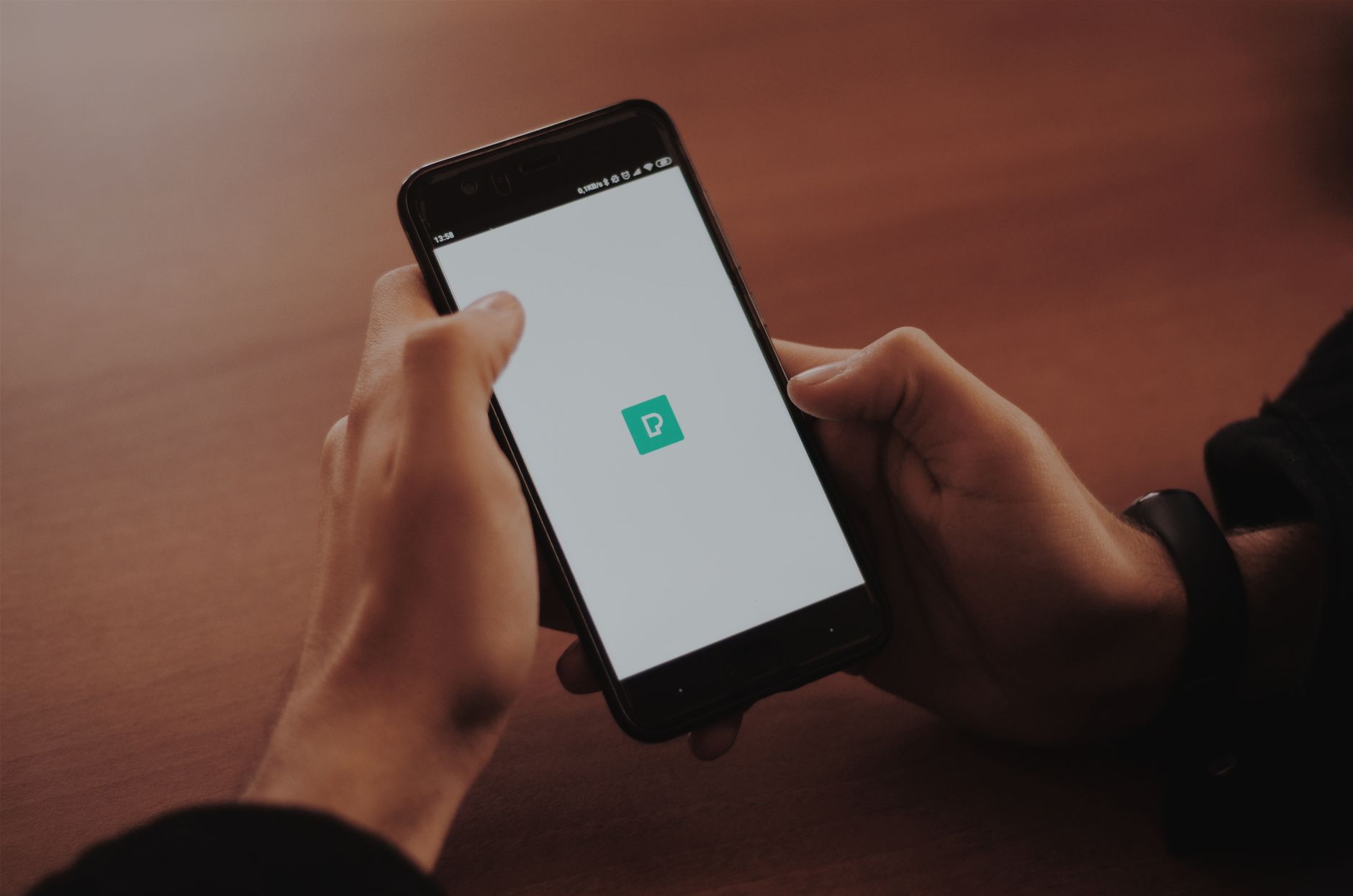 hand holding smartphone checking electricity meter app