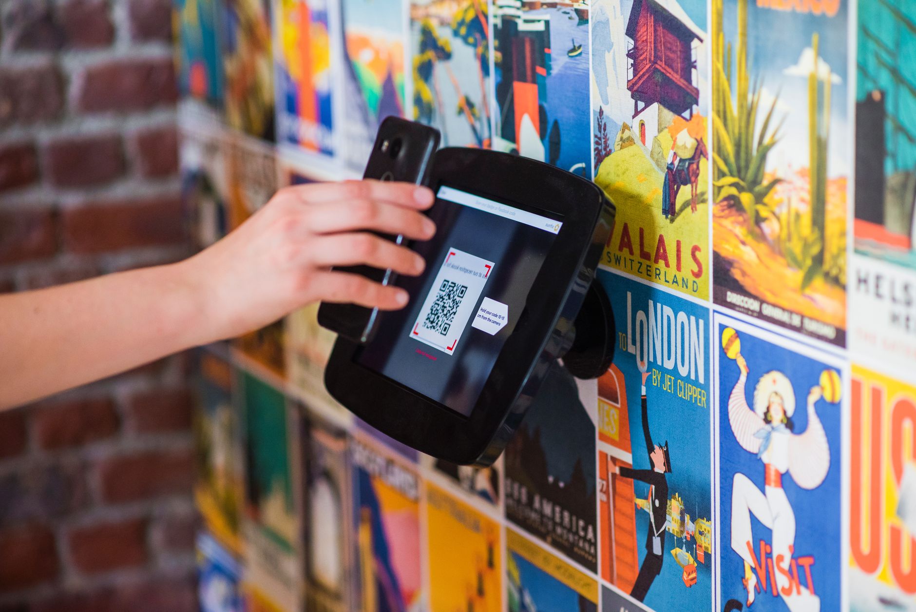 hand holding smartphone scanning QR code merchant