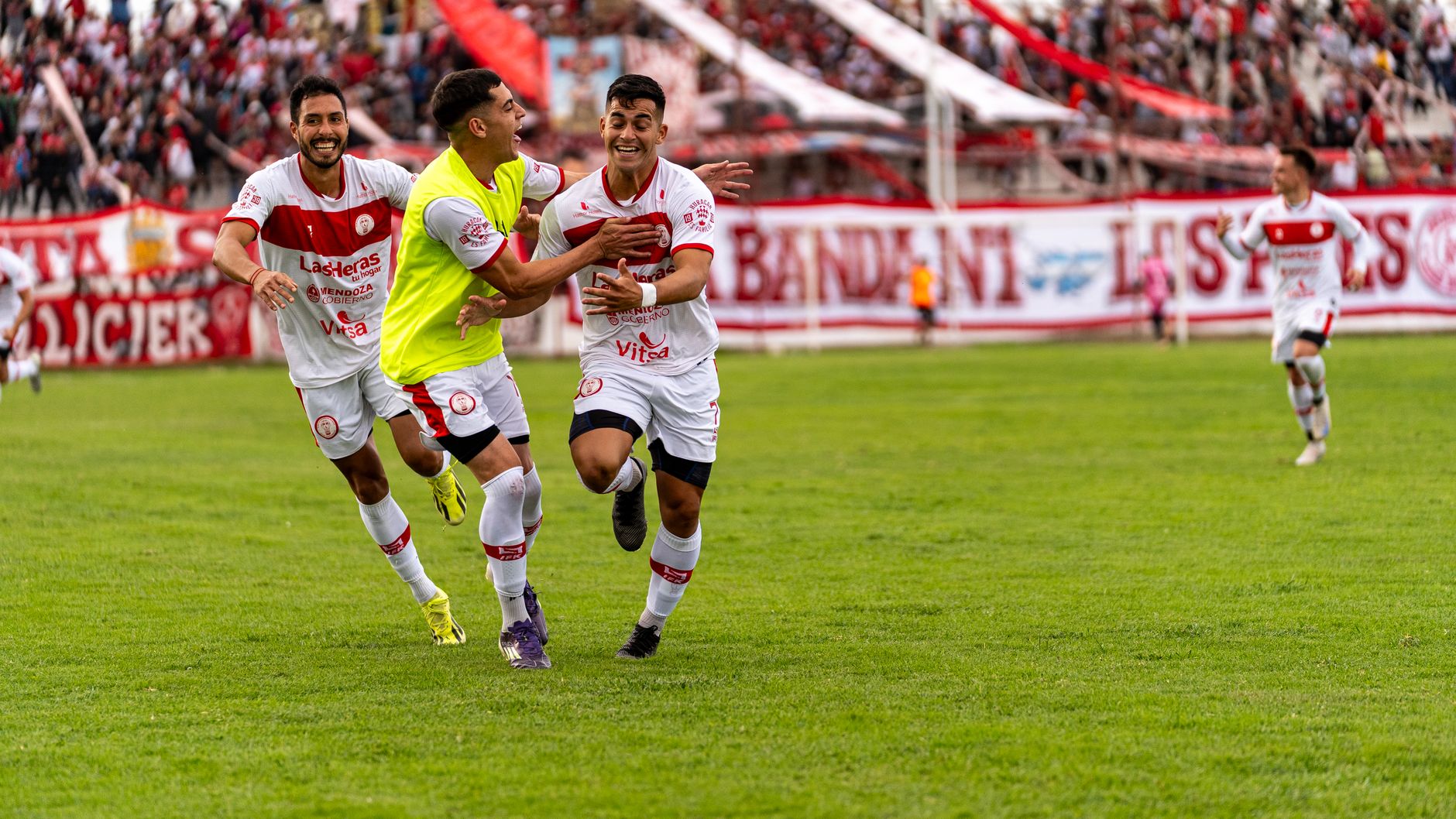 football players celebrating goal in stadium