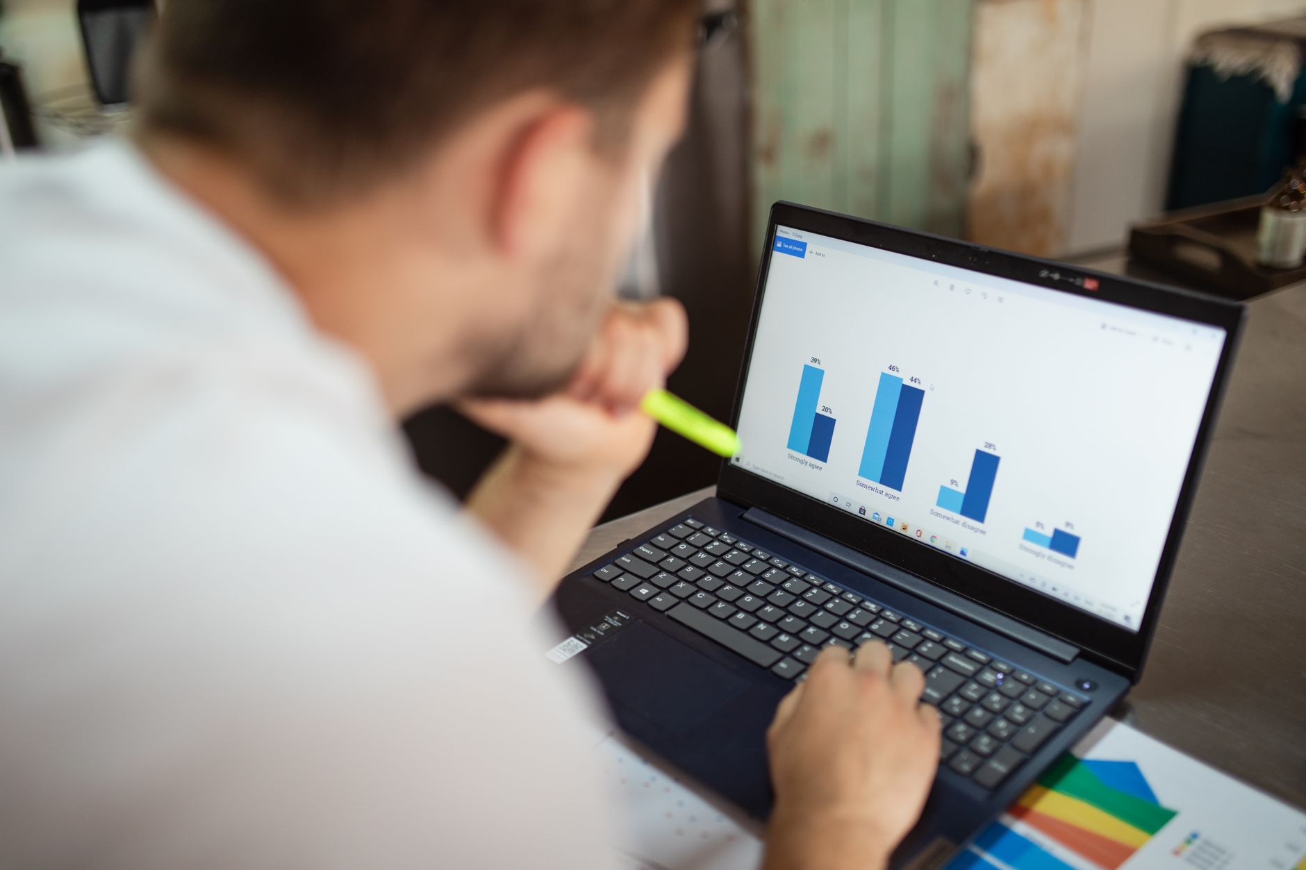 businessman reviewing financial charts on laptop in modern office