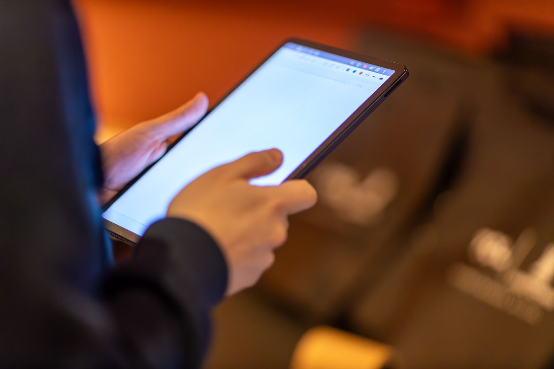 hands holding tablet browsing earthquake news