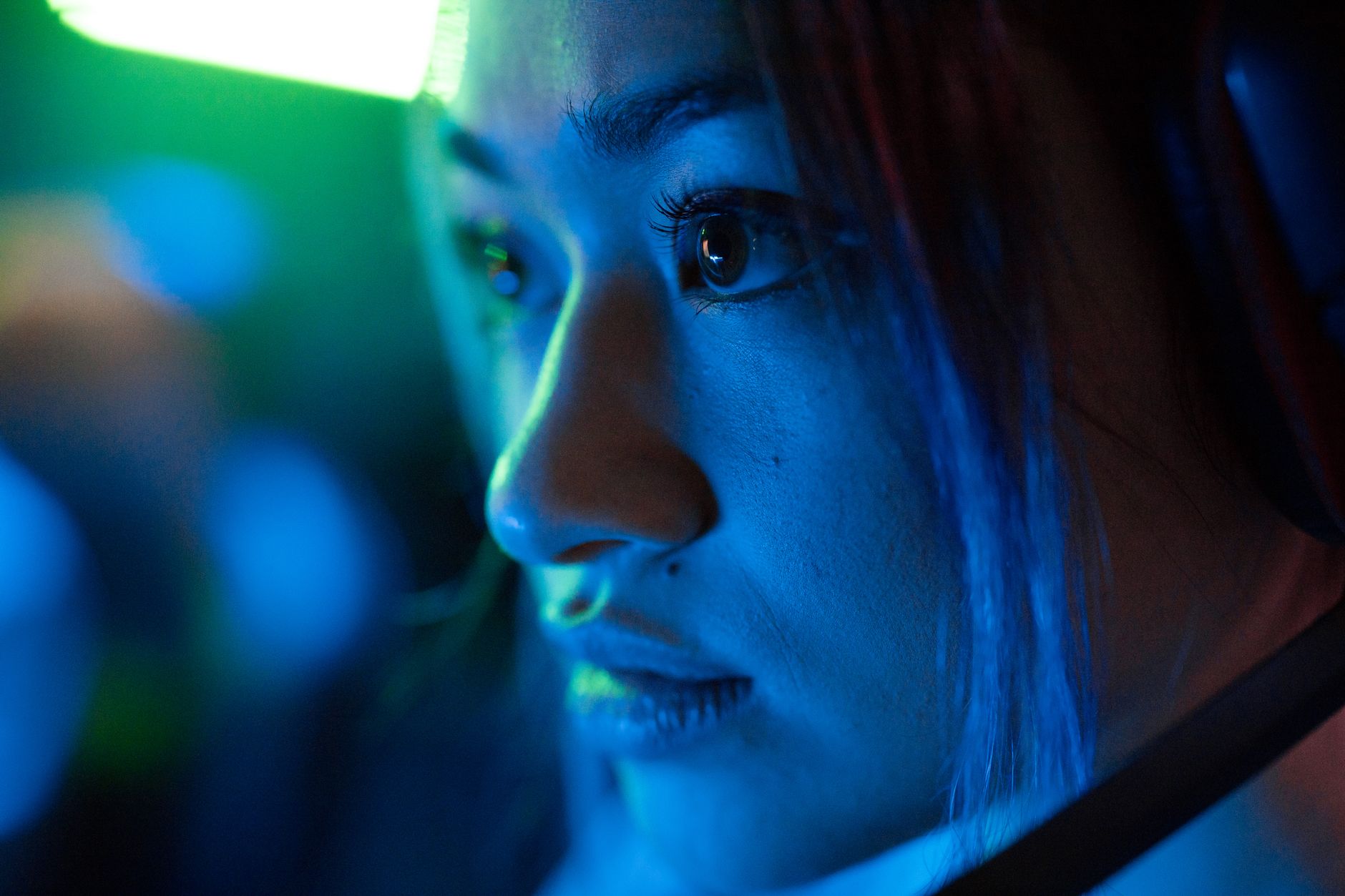 person wearing headset focused on screen