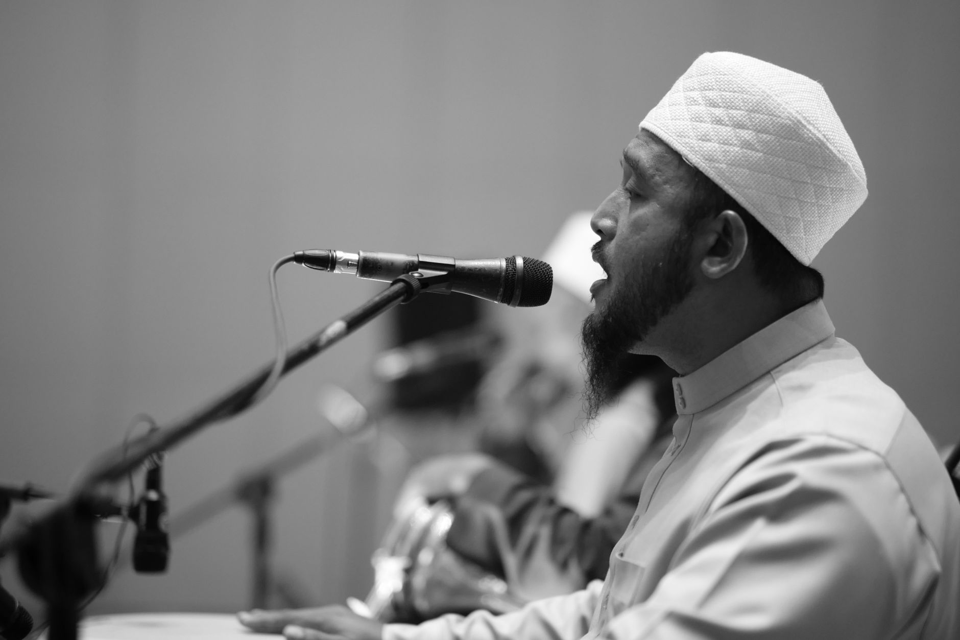 Muslim cleric speaking at podium with microphone