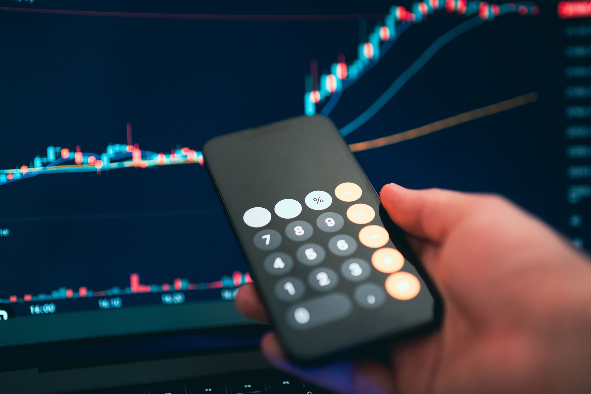 investor analyzing gold price chart on laptop