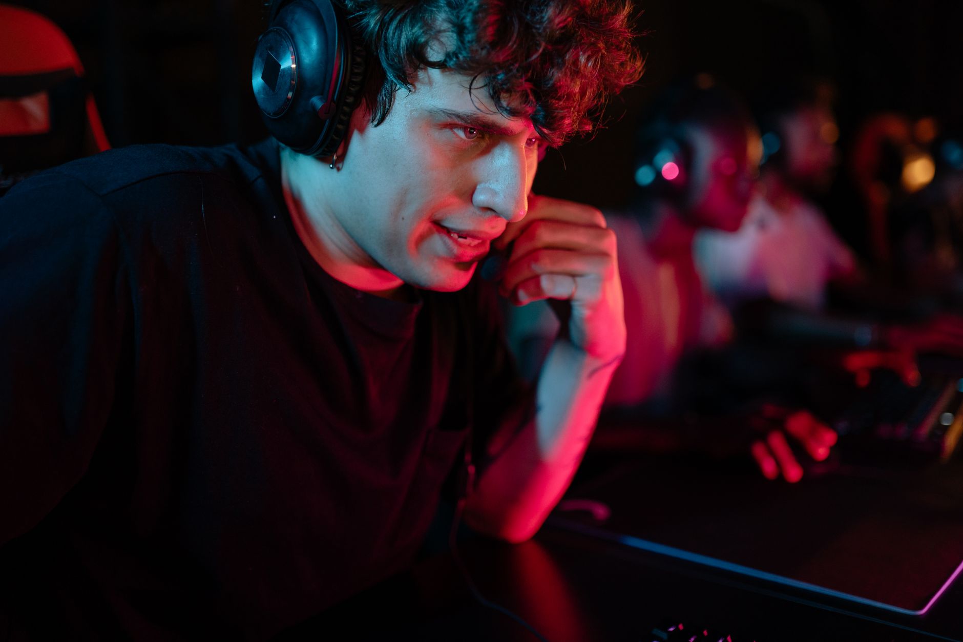 person wearing headset focused on screen