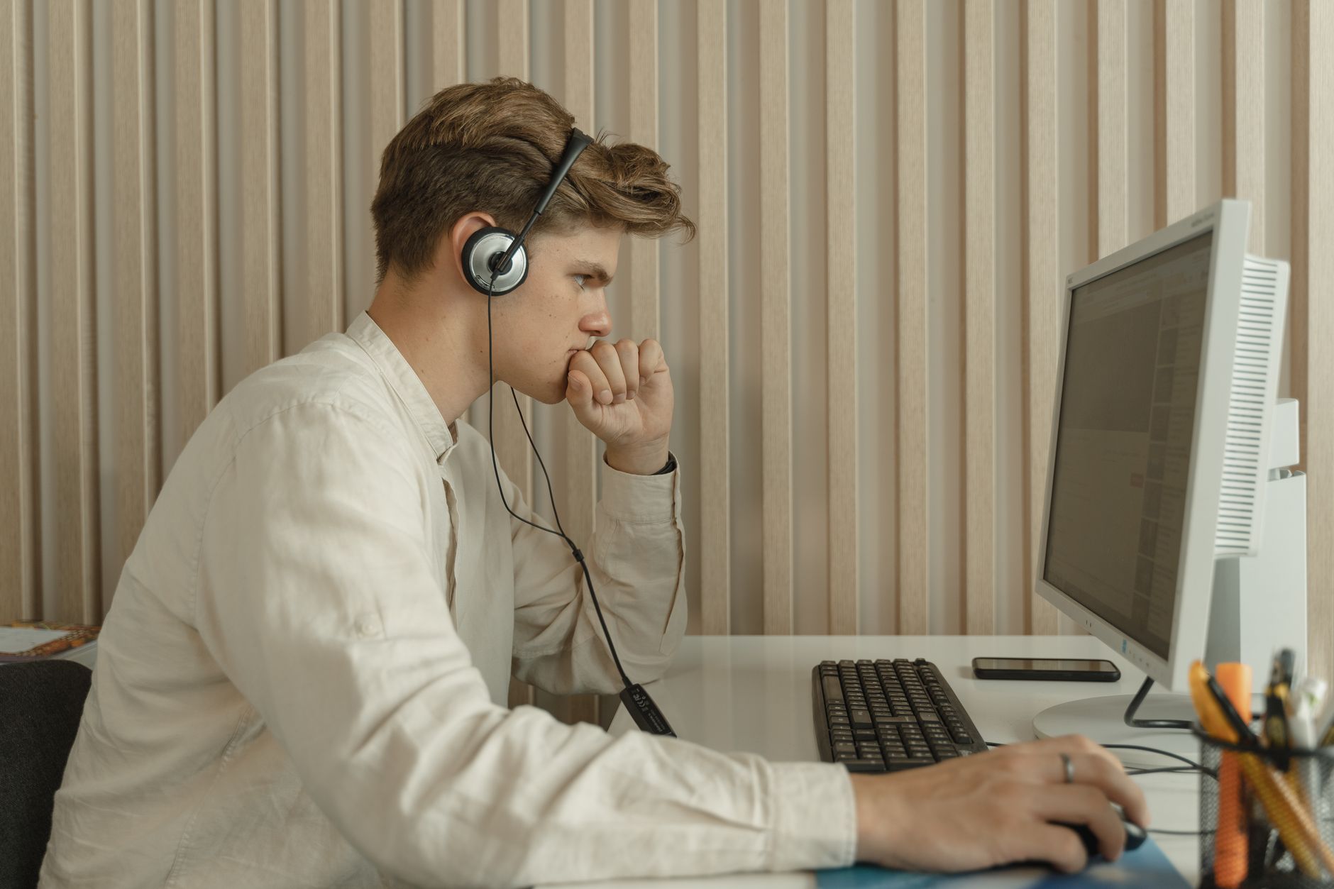 person wearing headset focused on screen