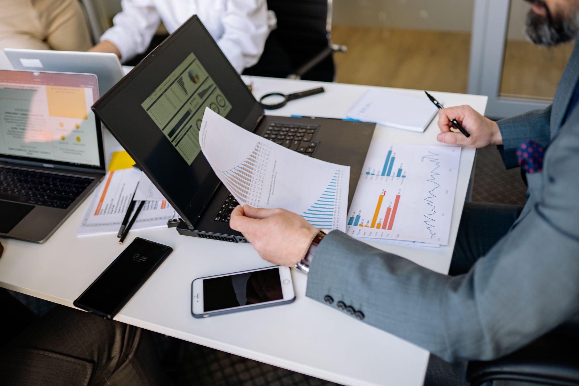 businessman reviewing financial charts laptop