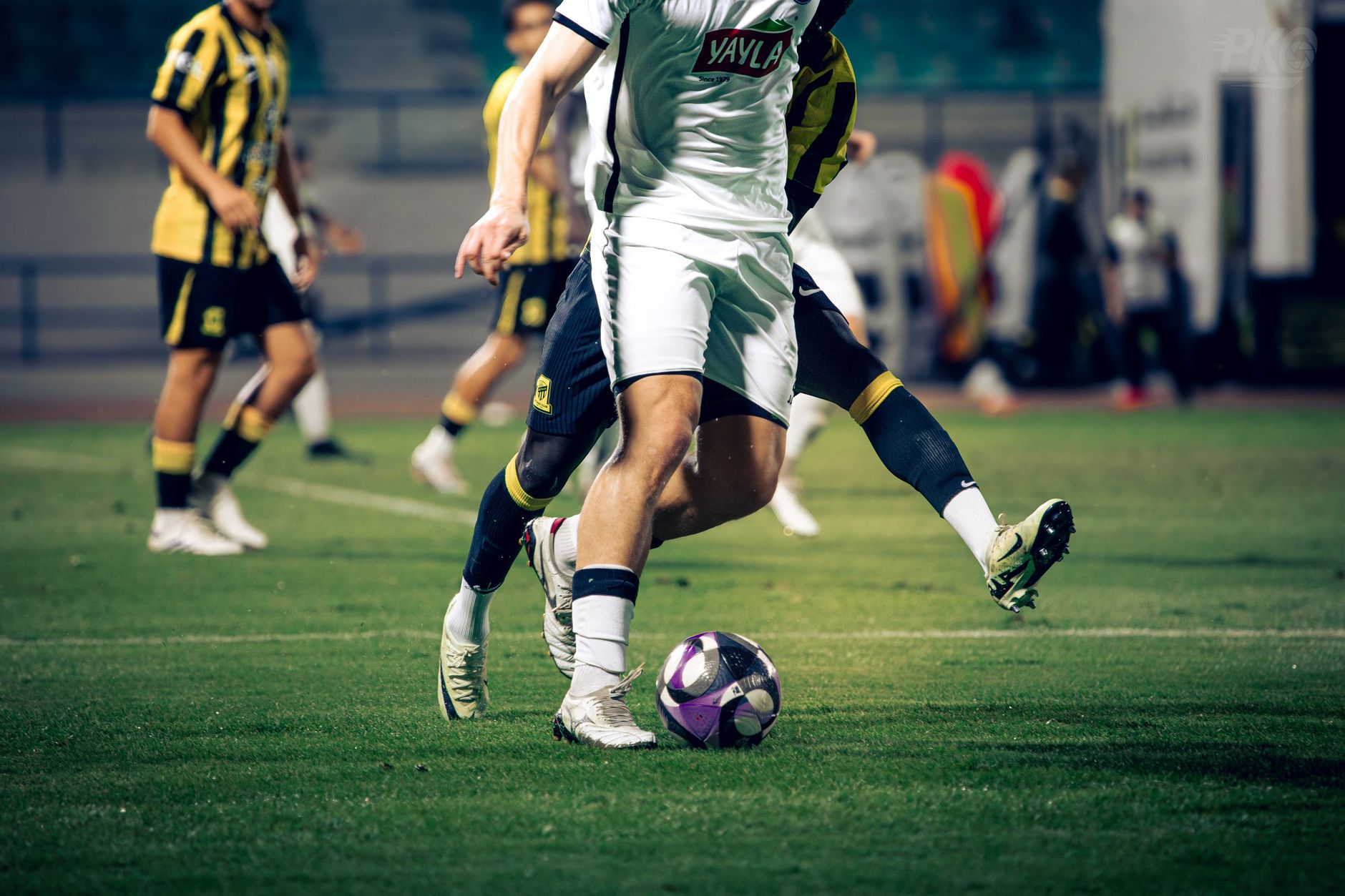 football players competing for ball on field