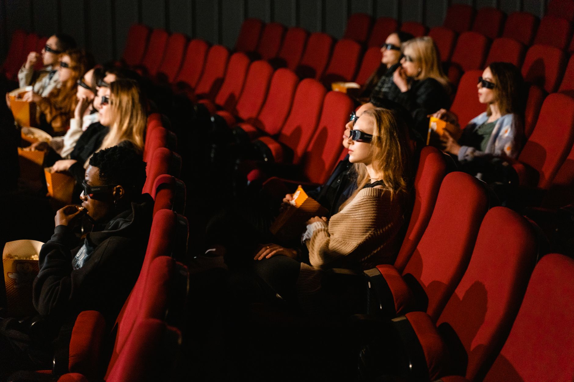 scared audience watching horror movie in cinema