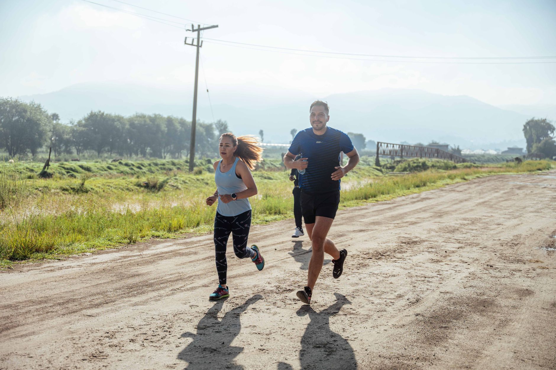 group of runners on scenic trail path