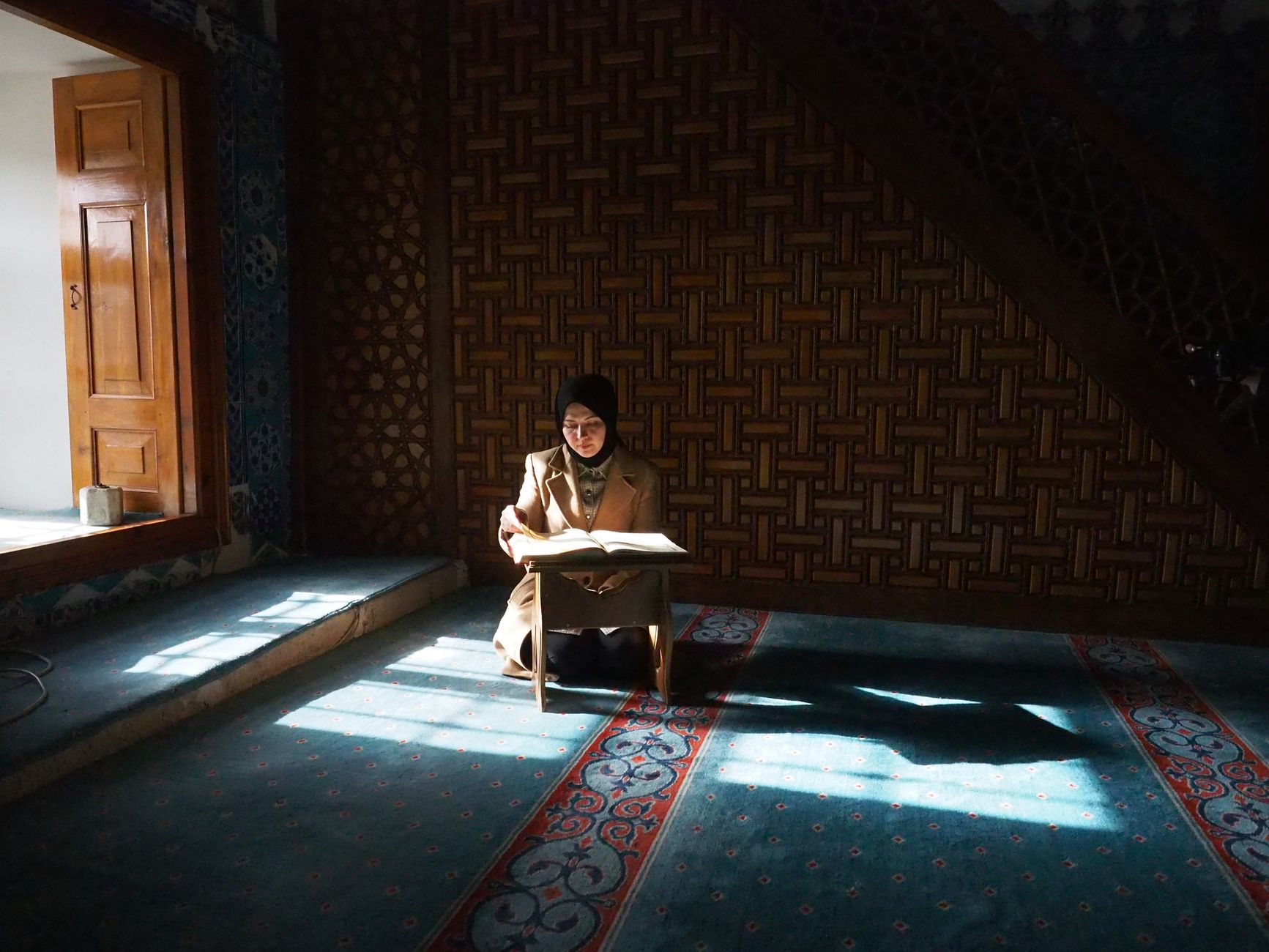person reading quran in quiet room