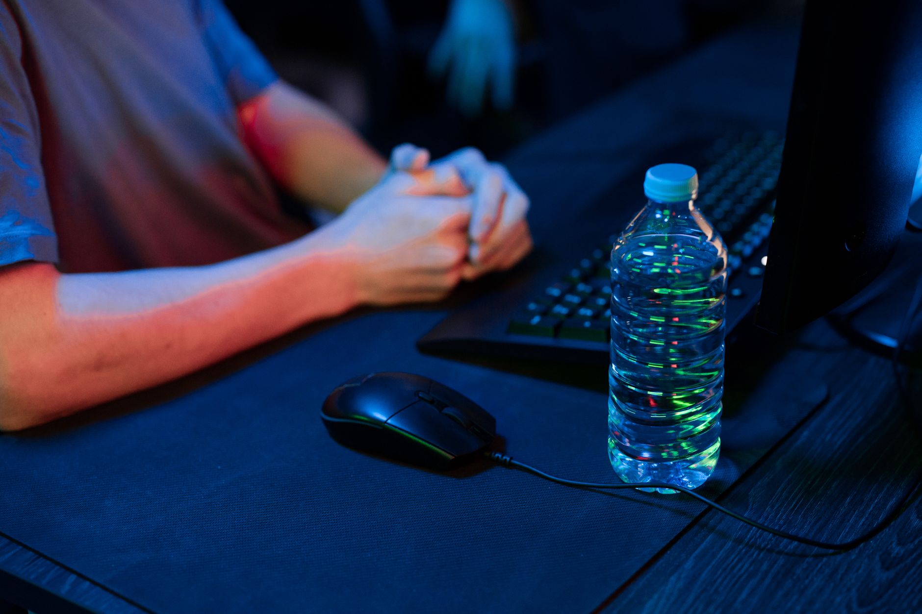 gamer hands on RGB keyboard playing game