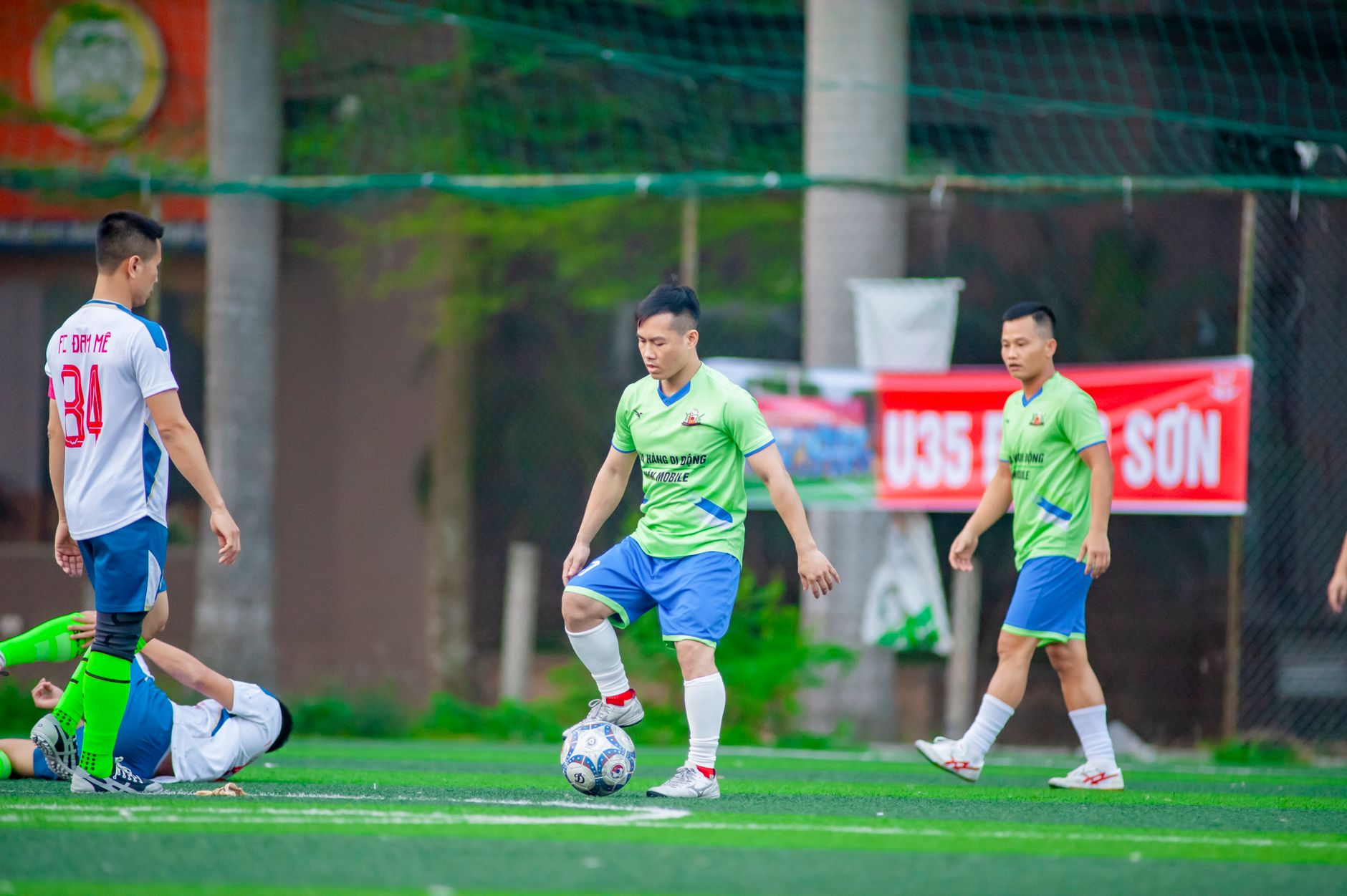 football players competing for ball on field