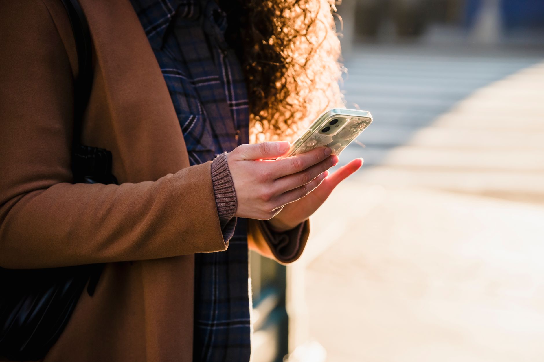 hands holding smartphone checking prayer times