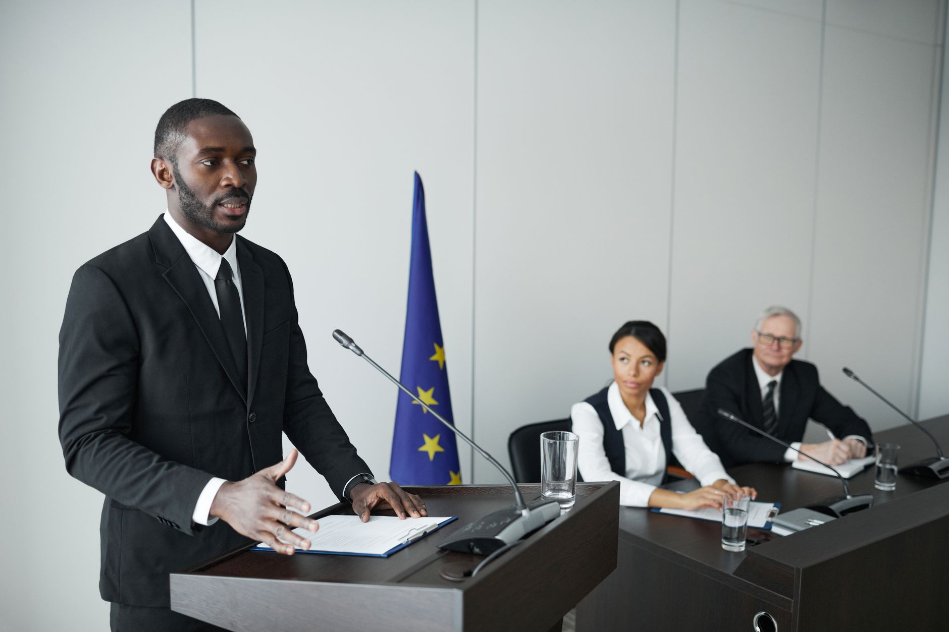 government official speaking at podium microphone