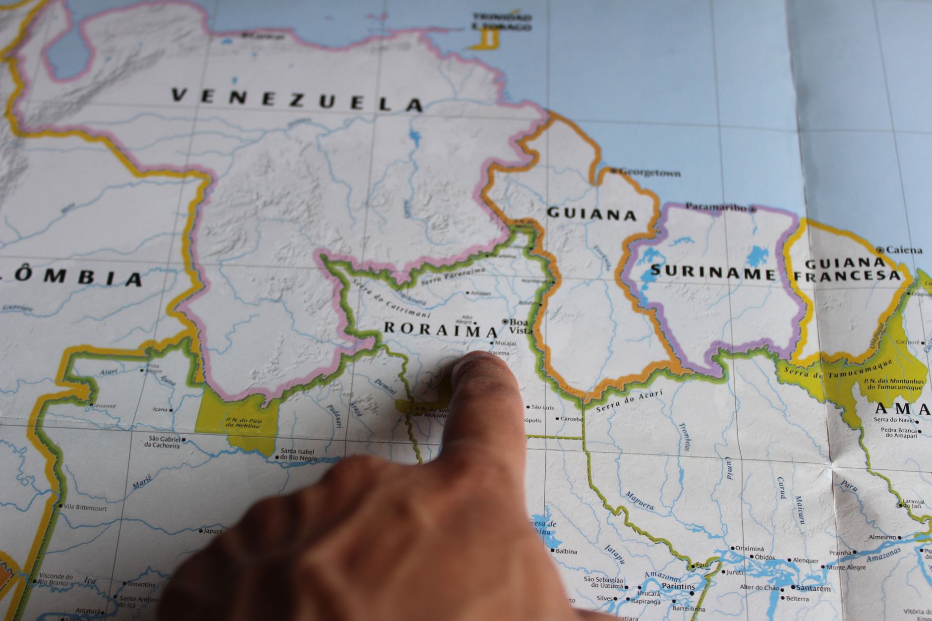 political analyst pointing at world map with news headlines