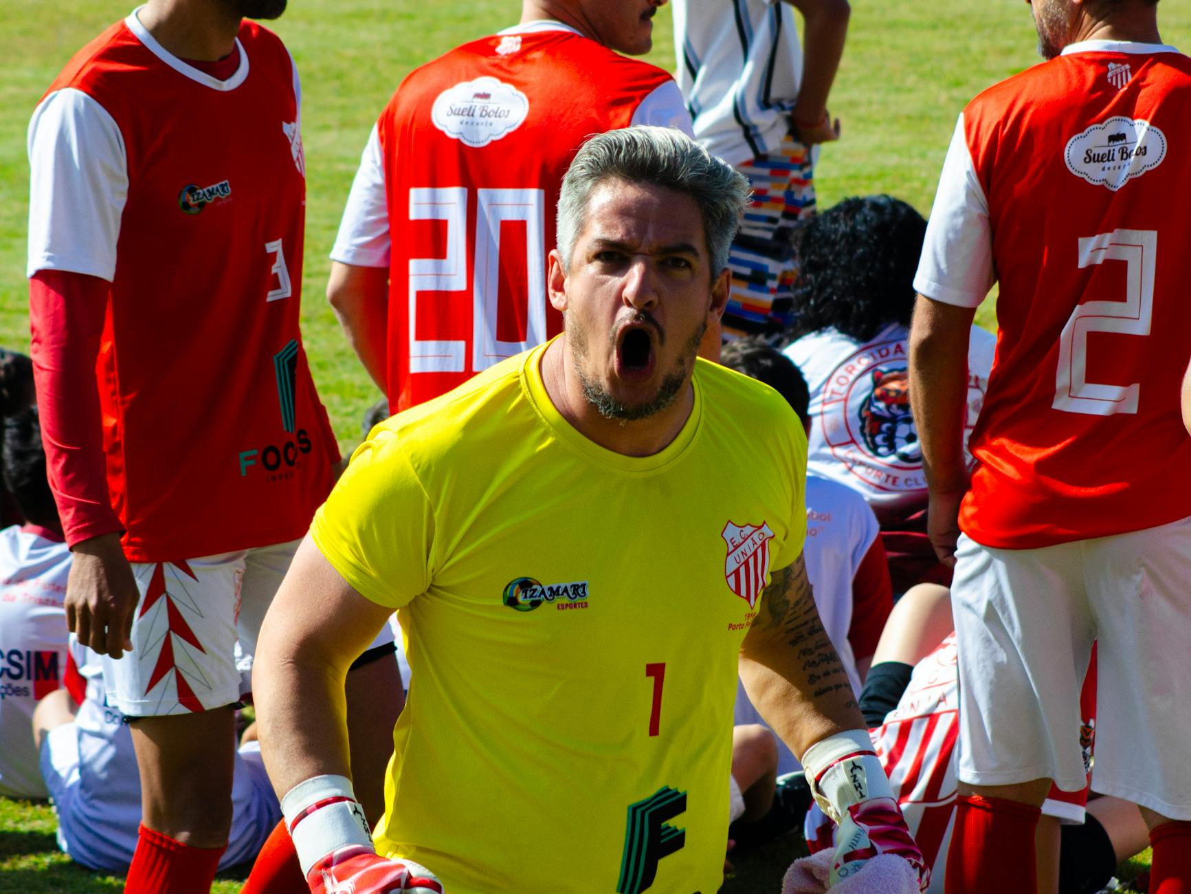 football player celebrating goal on field at stadium