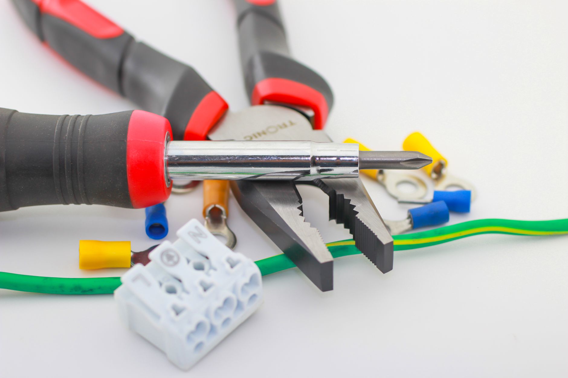 electrician hands connecting wires in fuse box