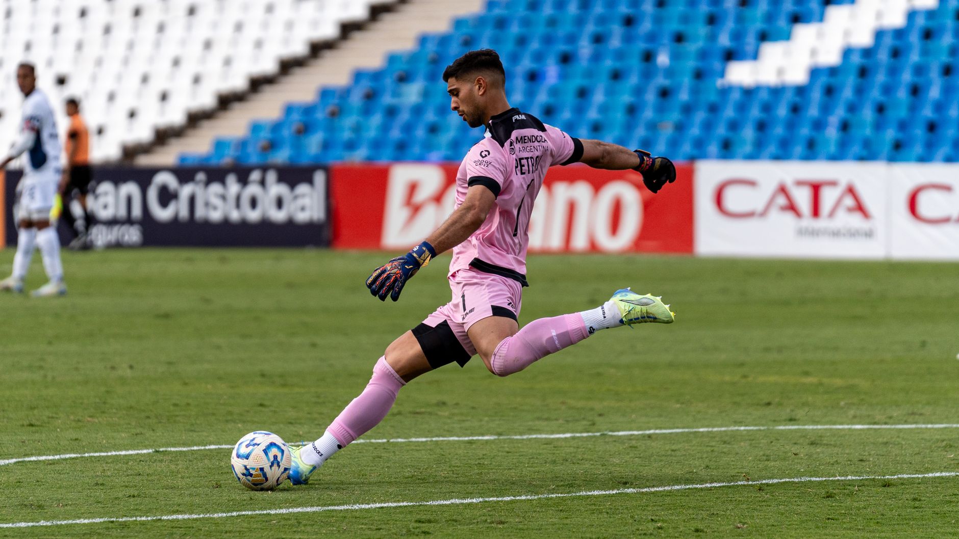 Young soccer player kicking ball stadium