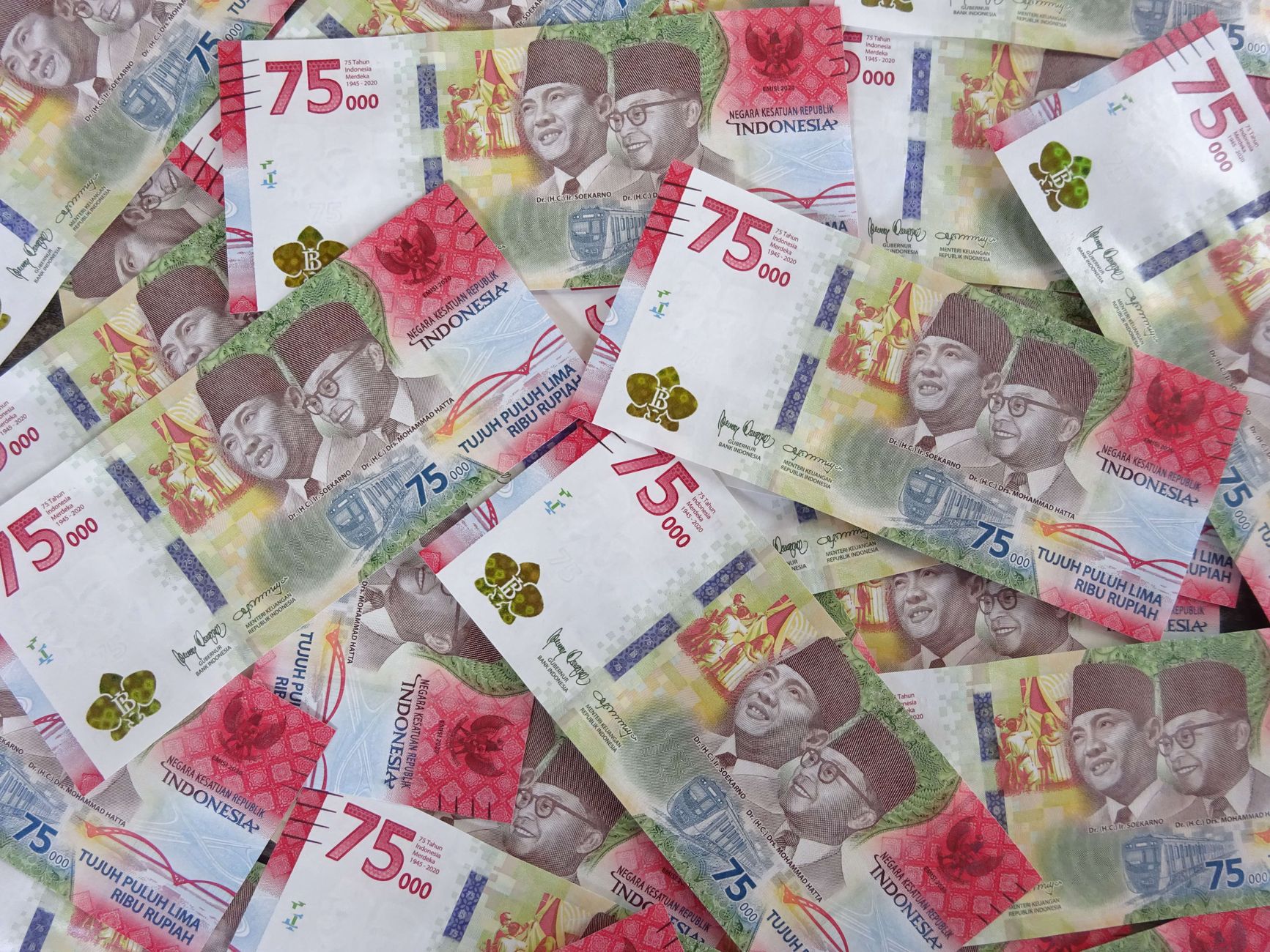rupiah banknotes spread on office desk